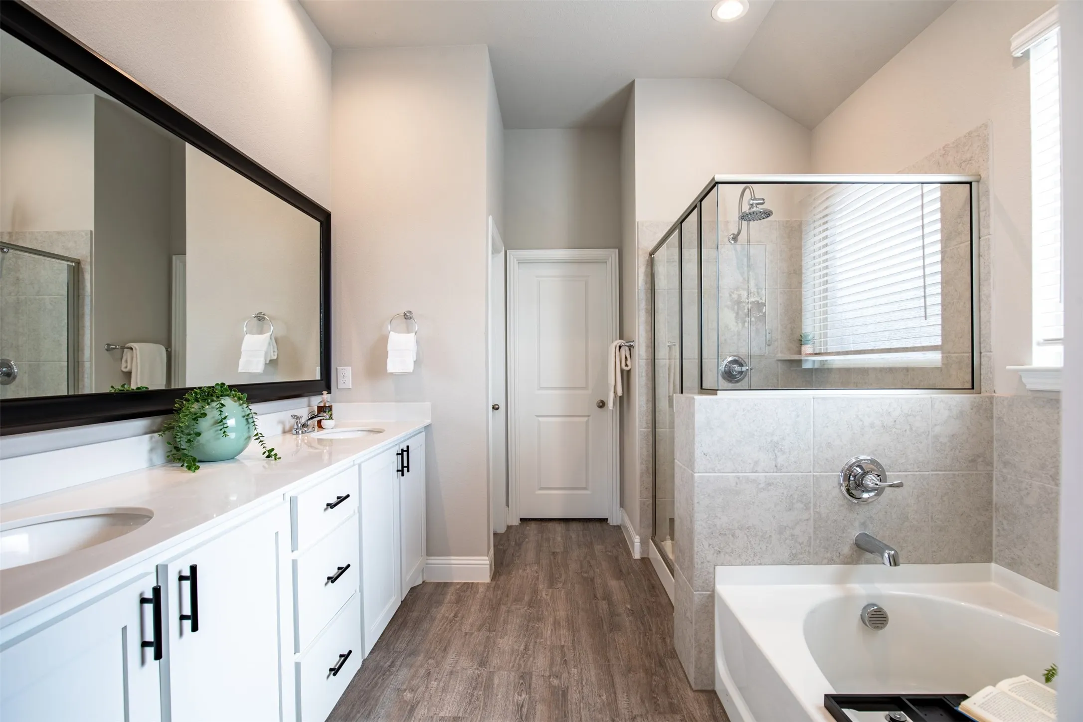Primary bath has dual sinks with plenty of storage space and a walk in closet.