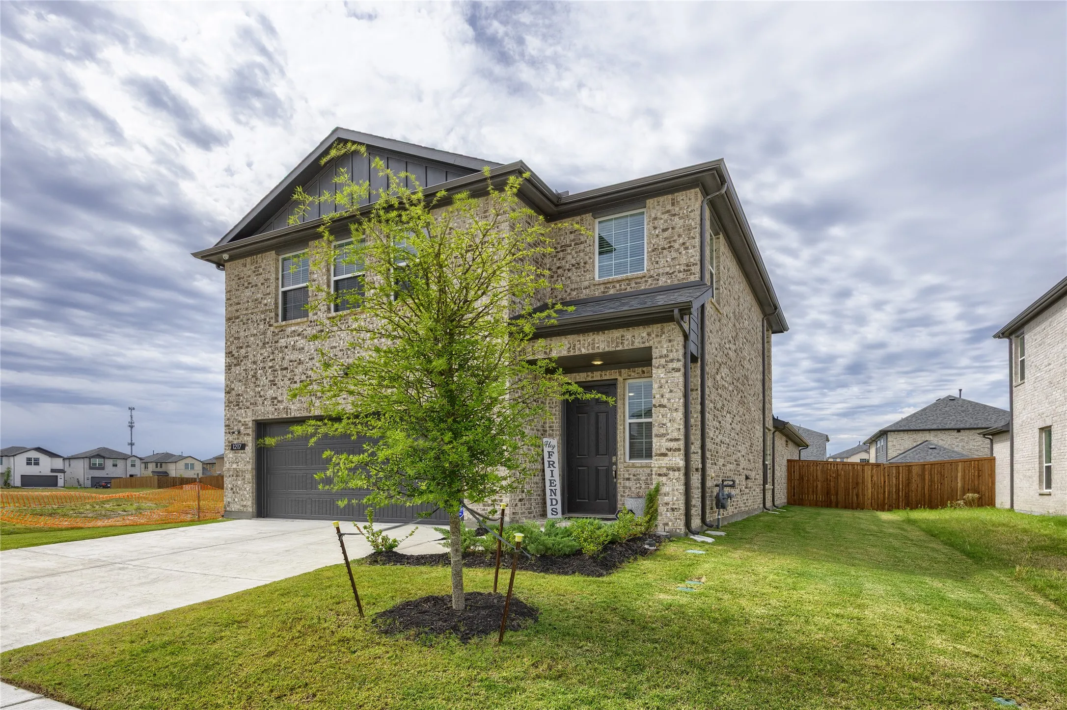 This angle clearly highlights the generous, additional spacing between properties, beautifully framed by the well-maintained lawn and a premium board-on-board privacy fence.