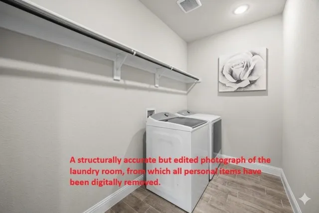 Functional laundry area featuring wood-finish flooring, a white baseboard trim, and light-toned walls