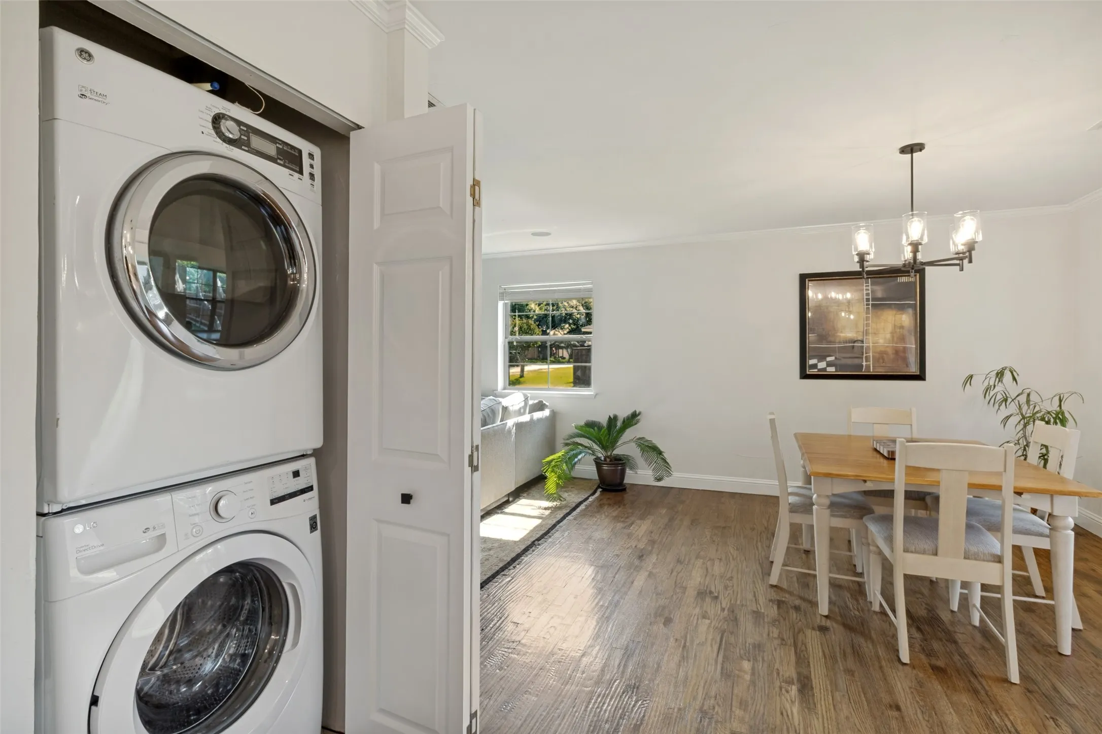 Integrated laundry closet featuring a stacked washer and dryer