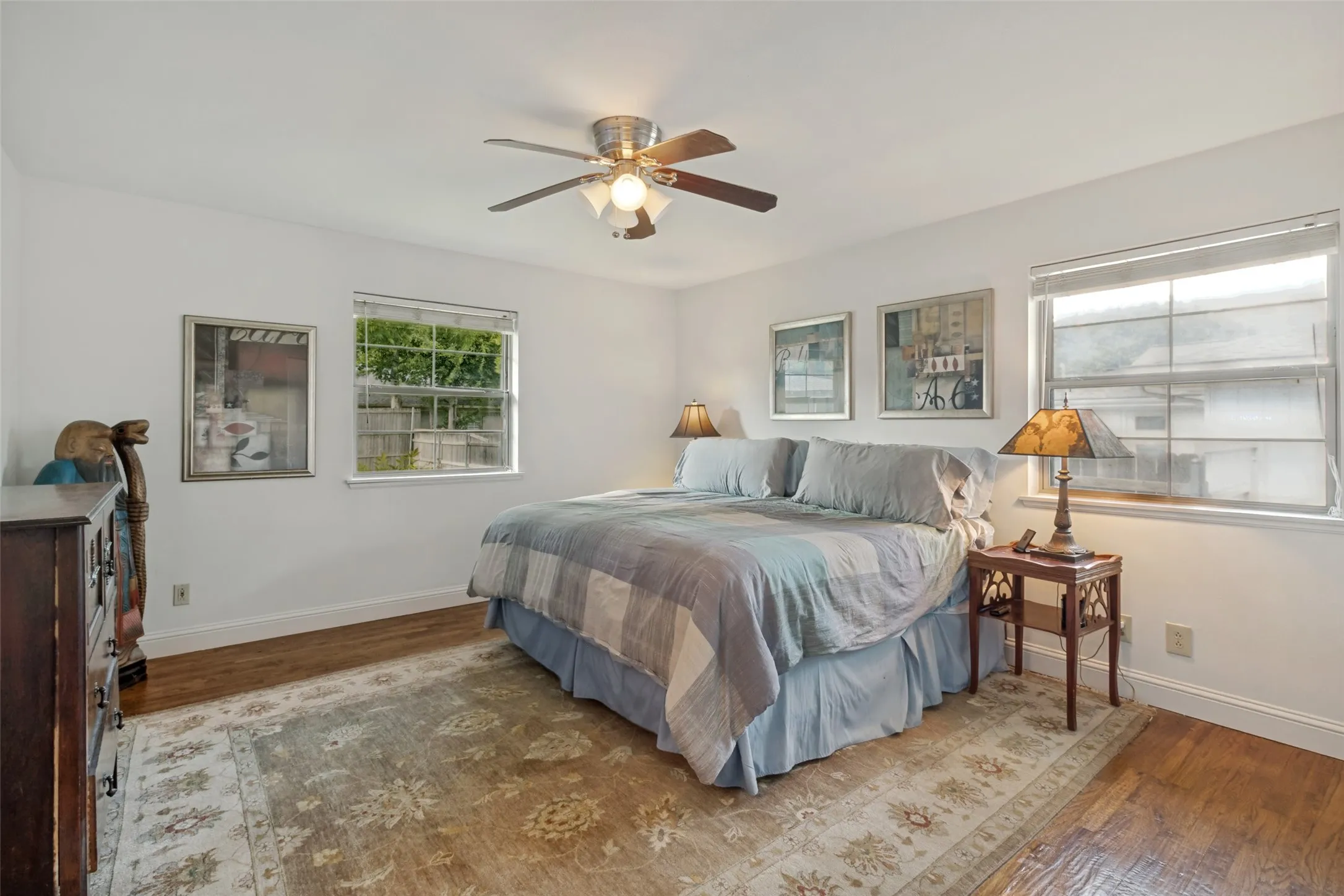 Bedroom featuring hardwood flooring, and 2 large windows