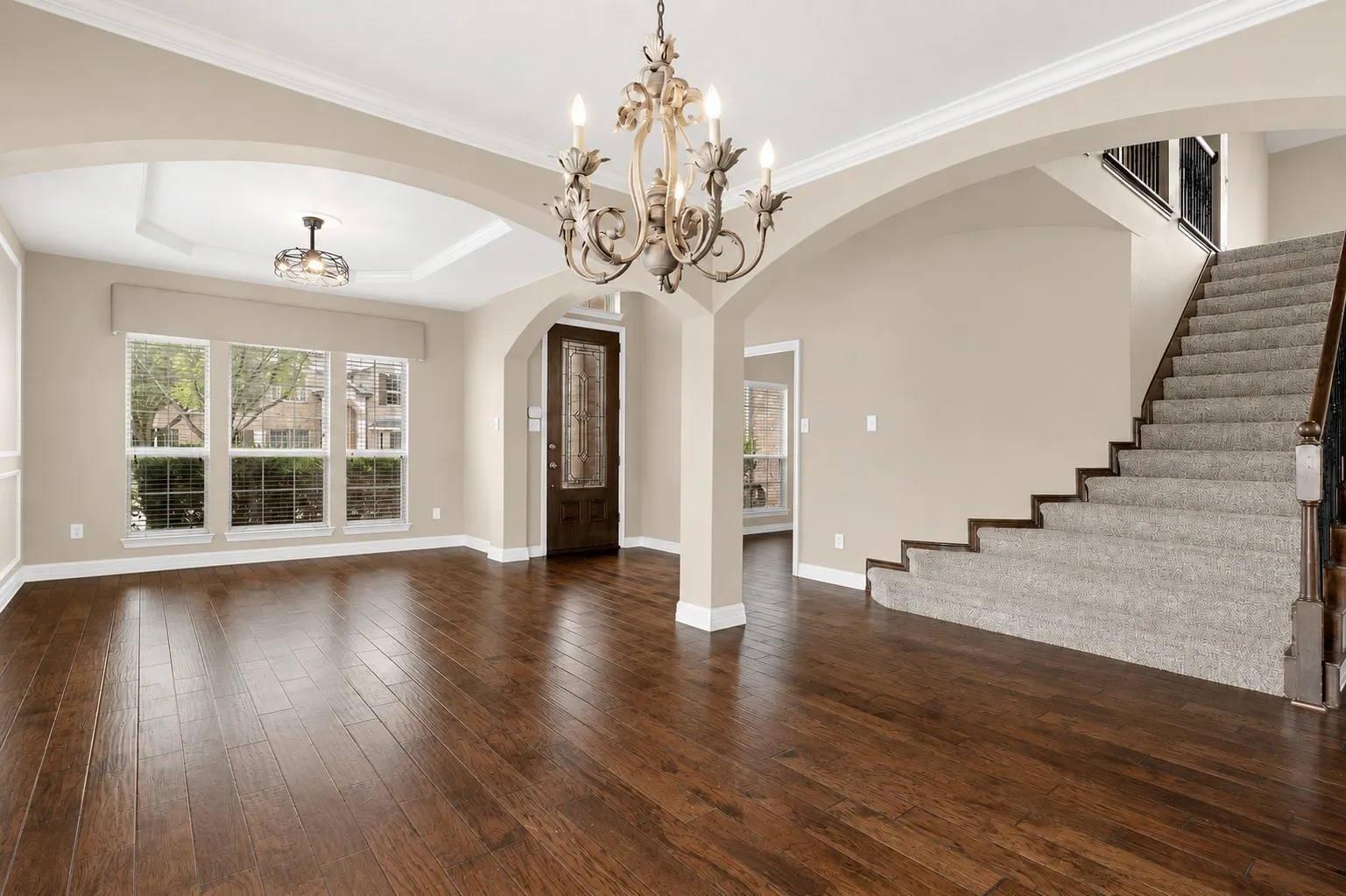 GORGEOUS WOOD FLOORING AND SWEEPING STAIRCASE