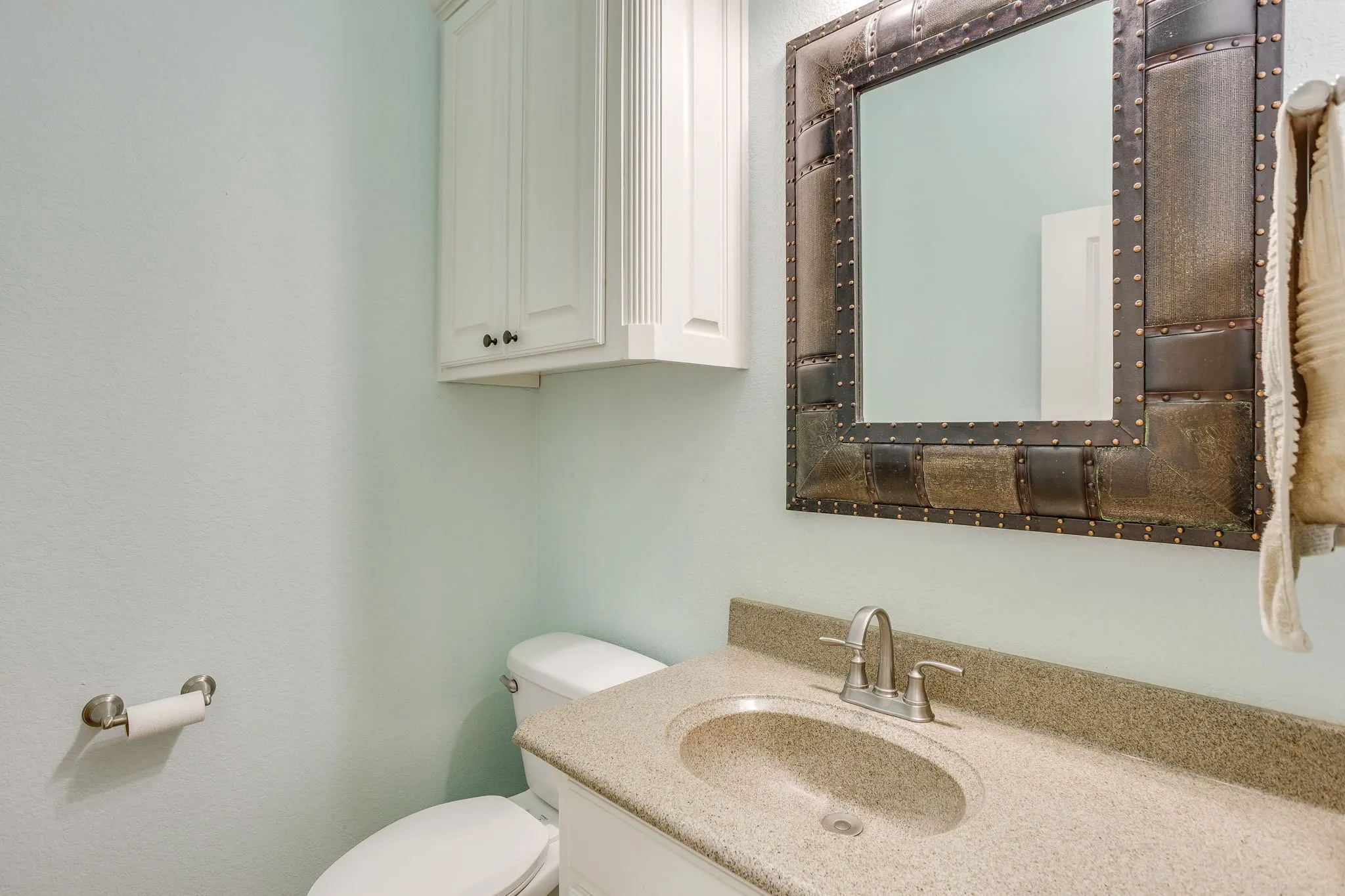 Vanity area featuring a built-in sink, stone-finish countertop, and brushed nickel faucet