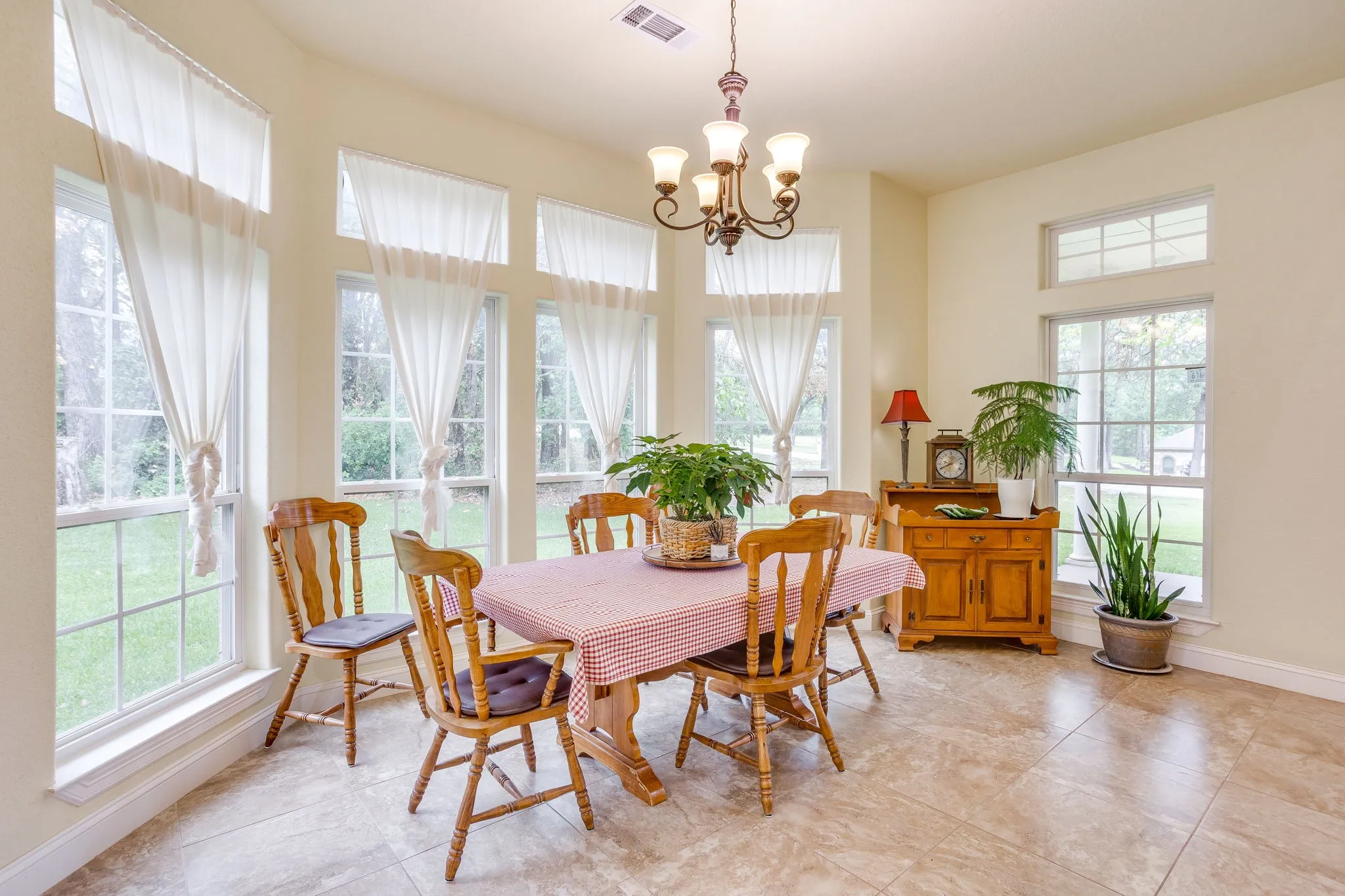Dining area with multiple windows, transom windows, and tile flooring