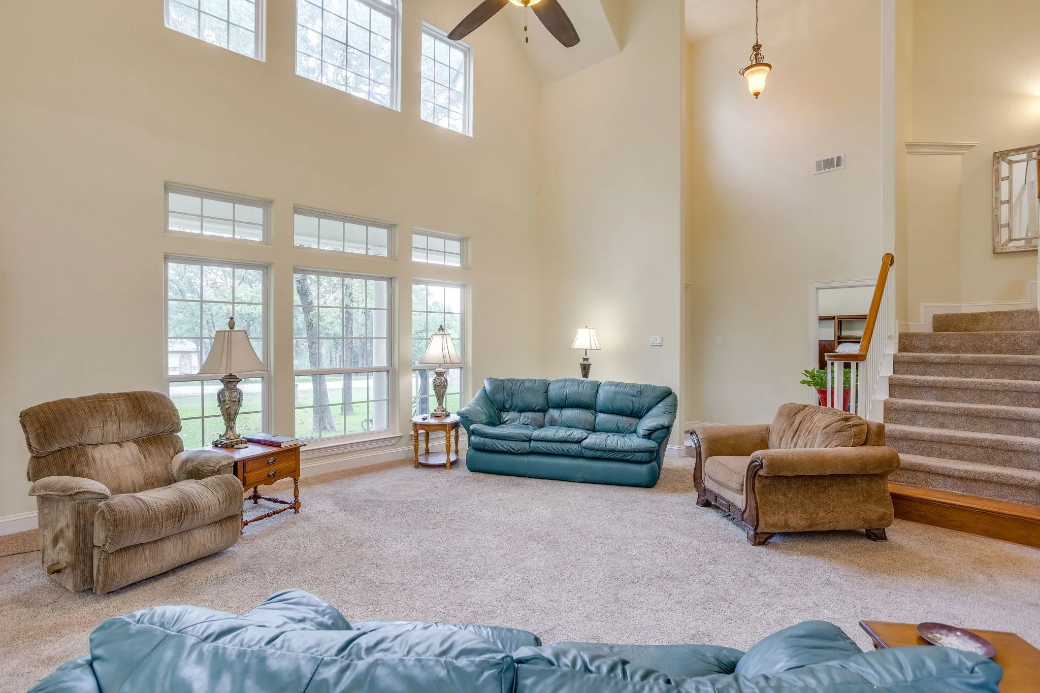 Two-story living area featuring a vaulted ceiling and extensive fenestration