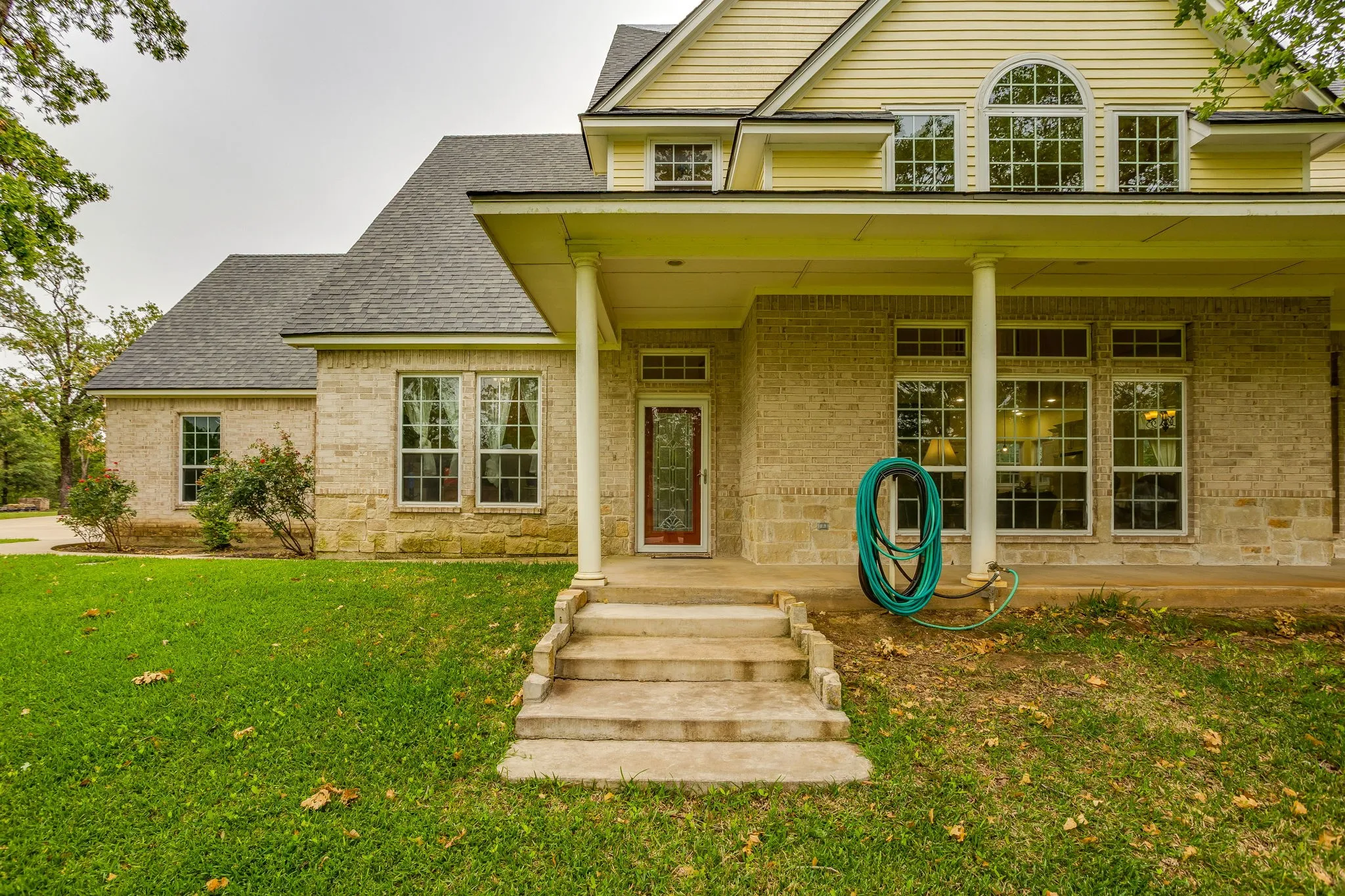 Stone and brick exterior with a prominent covered porch