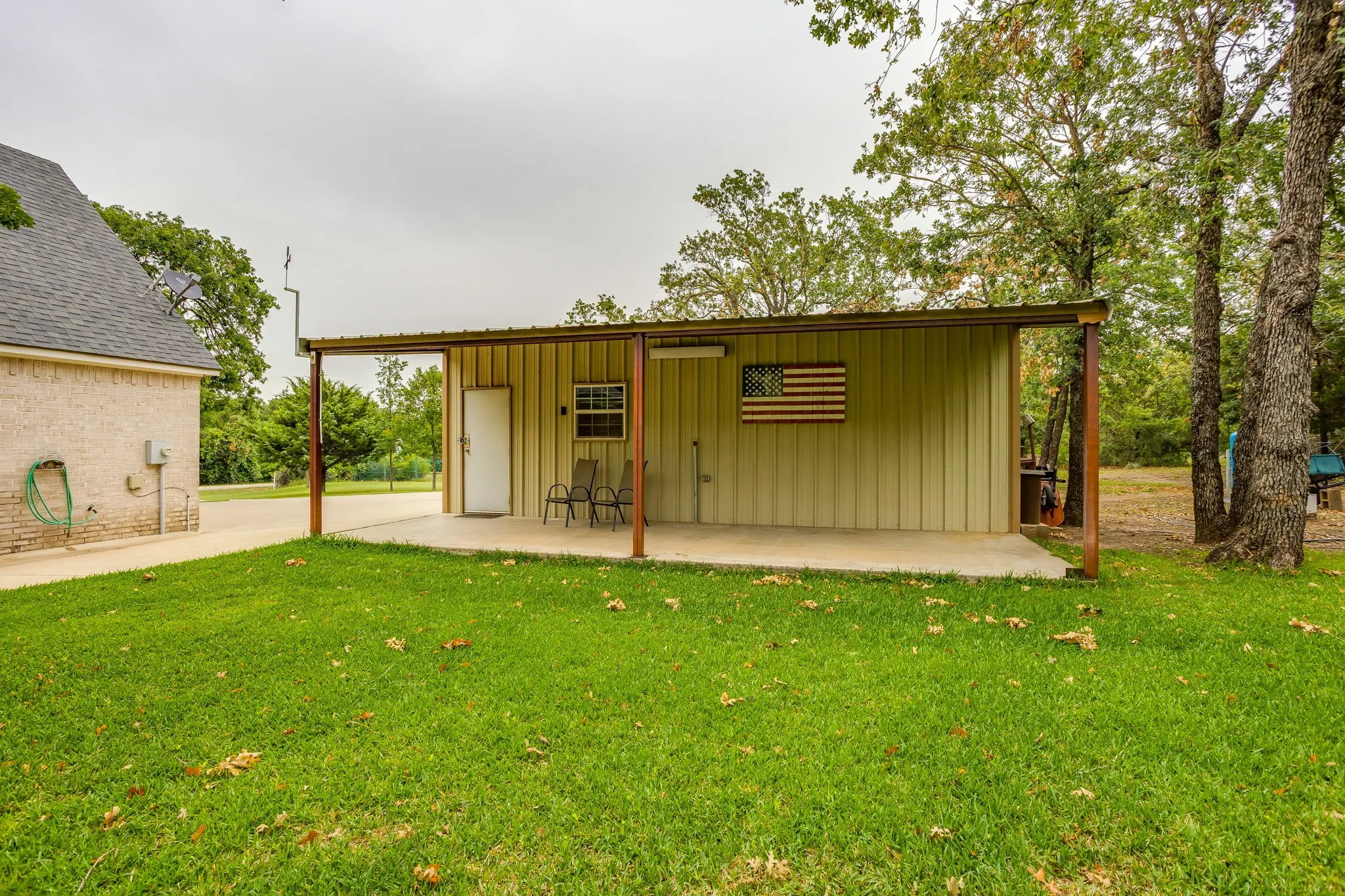 Detached metal-sided structure with an extended covered patio
