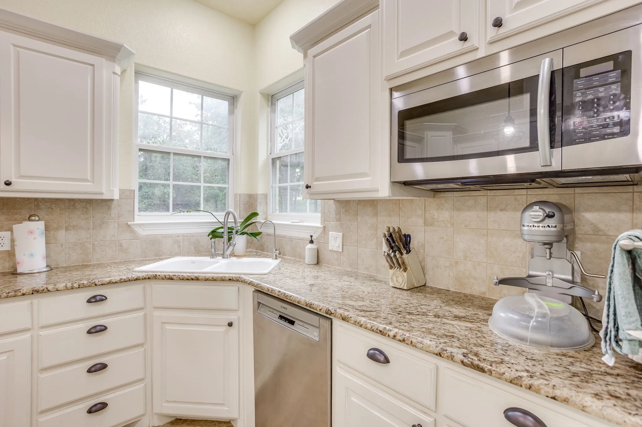 White cabinetry paired with granite countertops