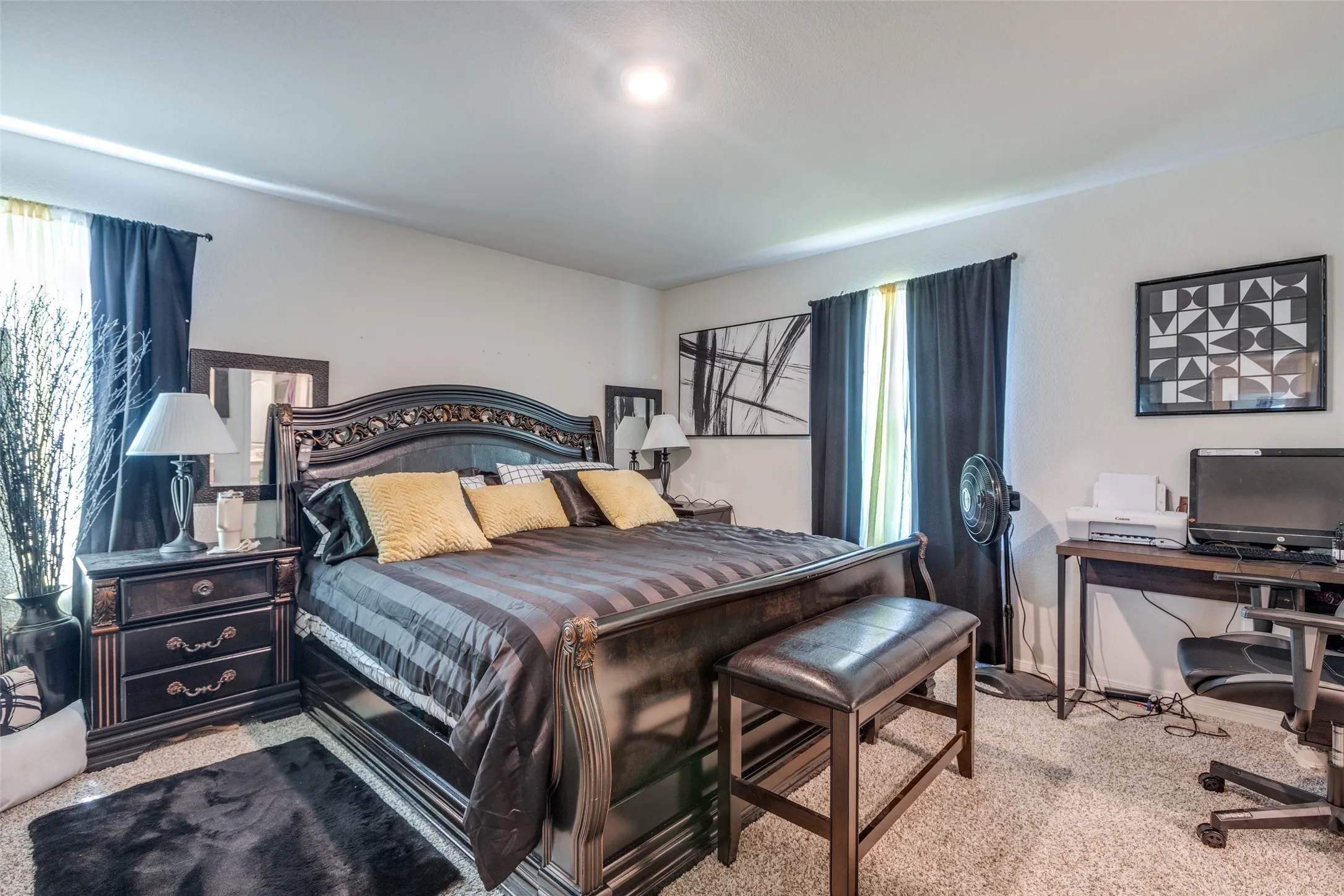Carpeted bedroom with a desk