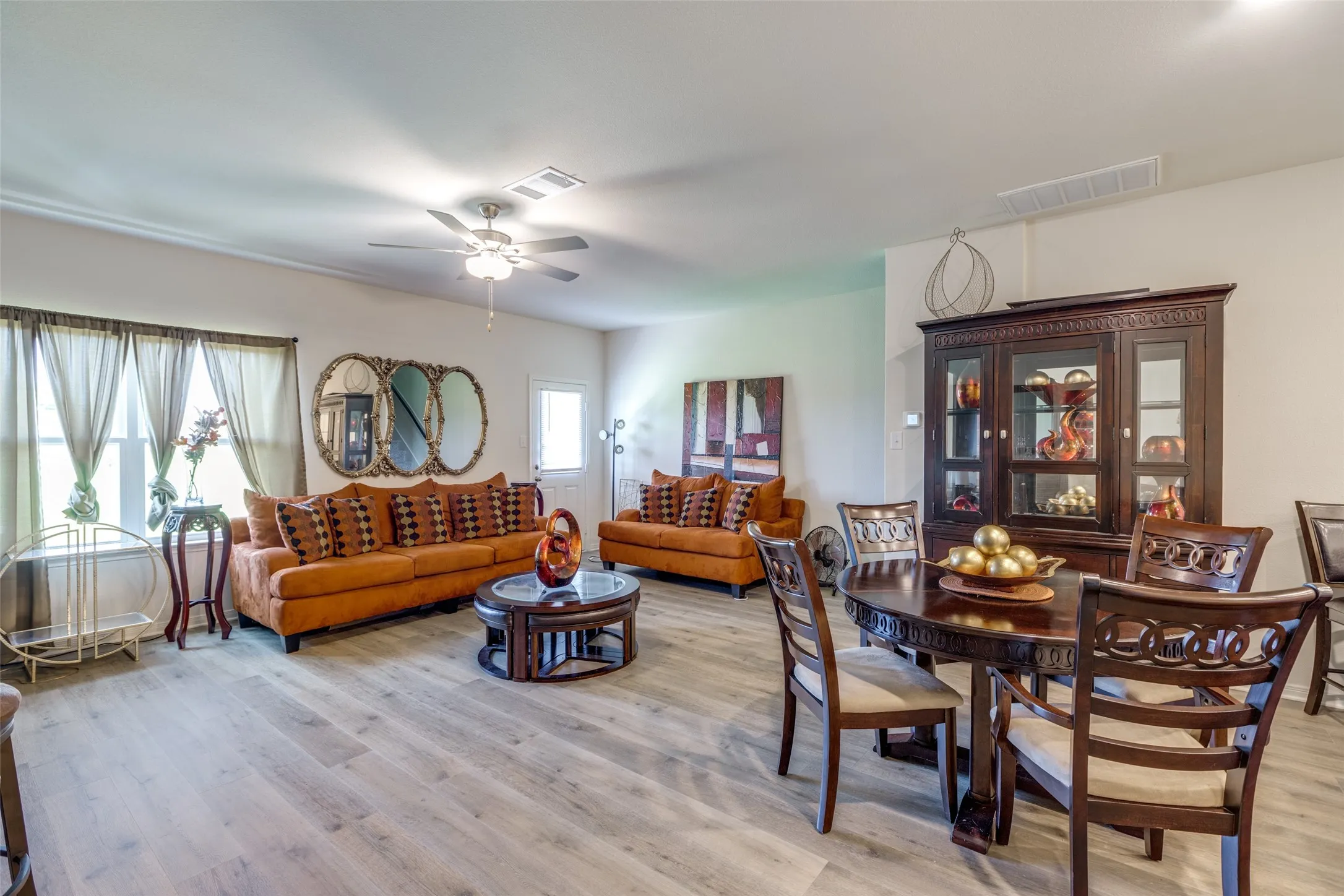 Dining space with light wood-style flooring and ceiling fan