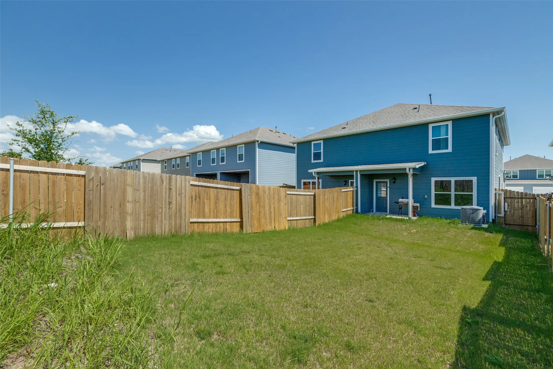 Rear view of property with a fenced backyard