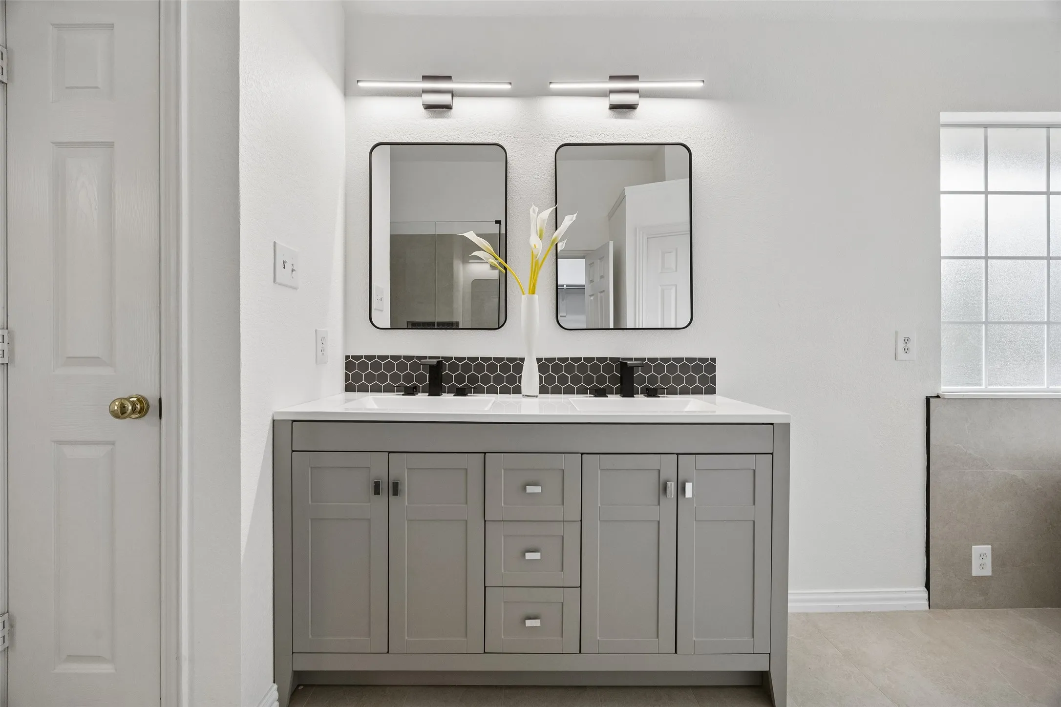 Dual vanity with a white countertop and undermount sinks