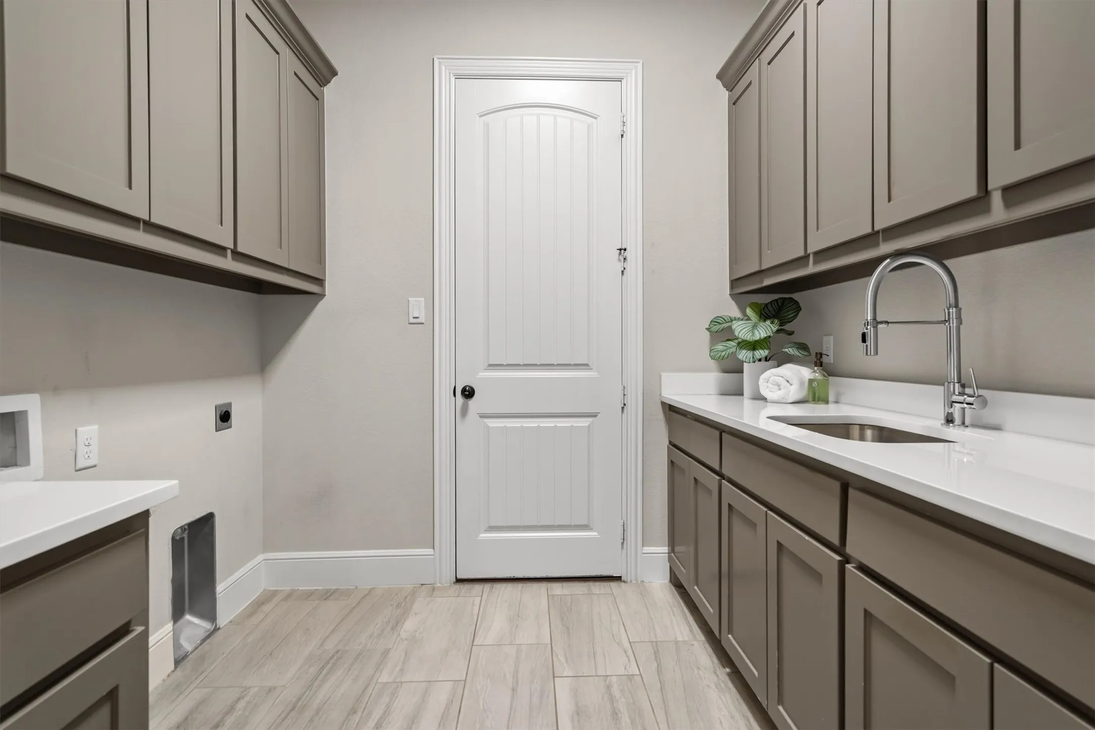 spacious laundry room with access to third car garage