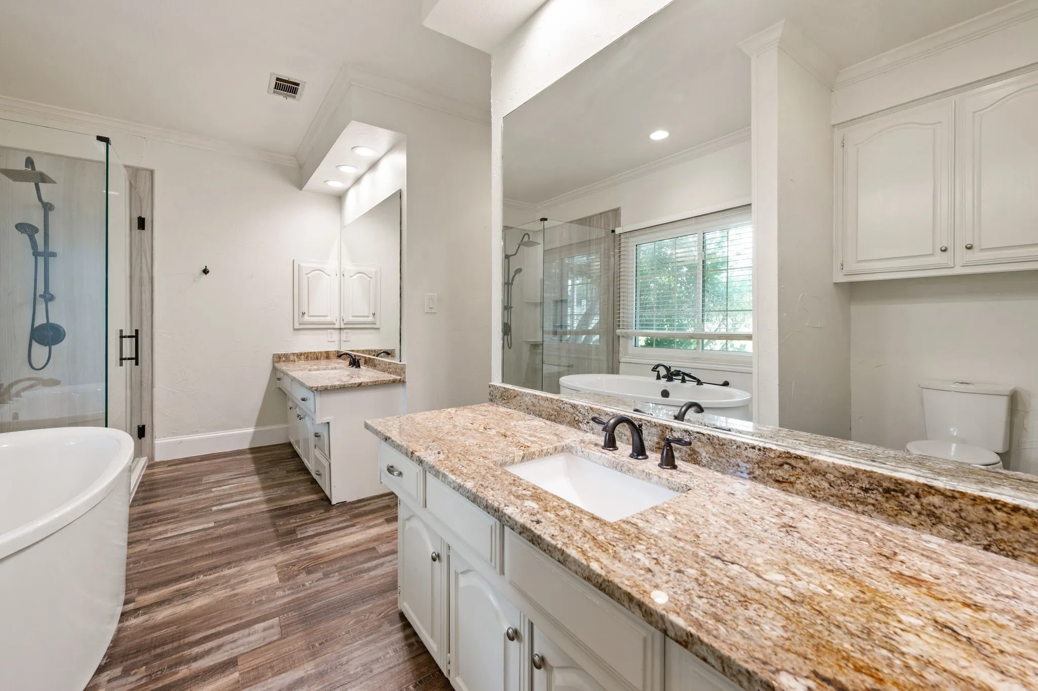 Separate granite counter vanities with under mount sinks and 2 closets
