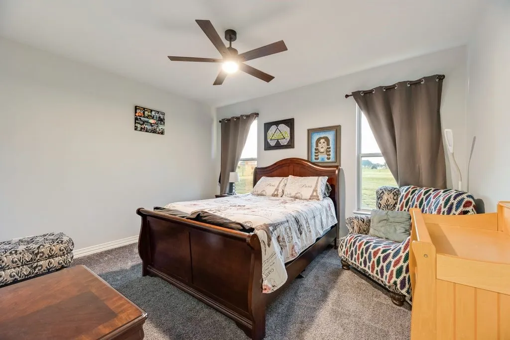 Room featuring light gray walls and gray carpeting