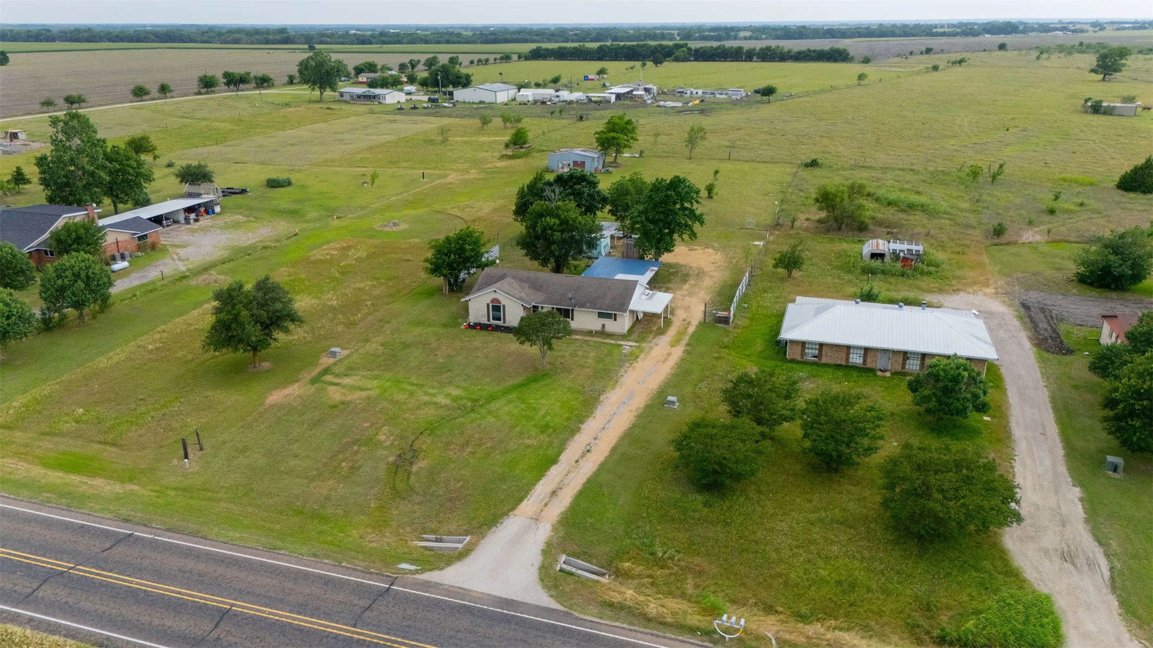 Expansive rural property featuring multiple residential structures and extensive open land