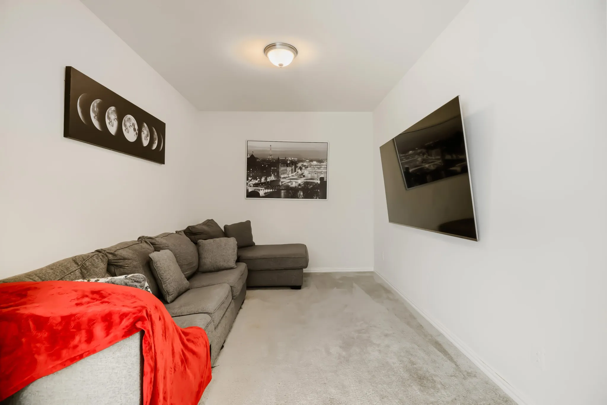 Bright interior room featuring light gray carpeting and white painted walls