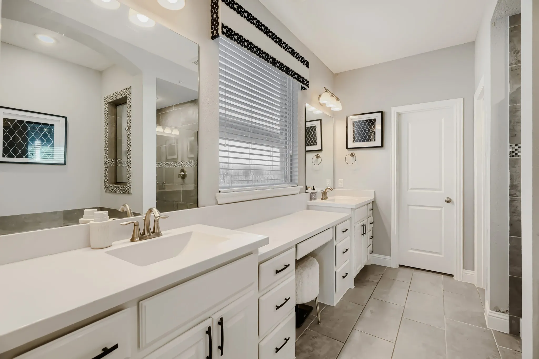 Double vanity with white cabinetry, integrated sinks, and brushed nickel fixtures