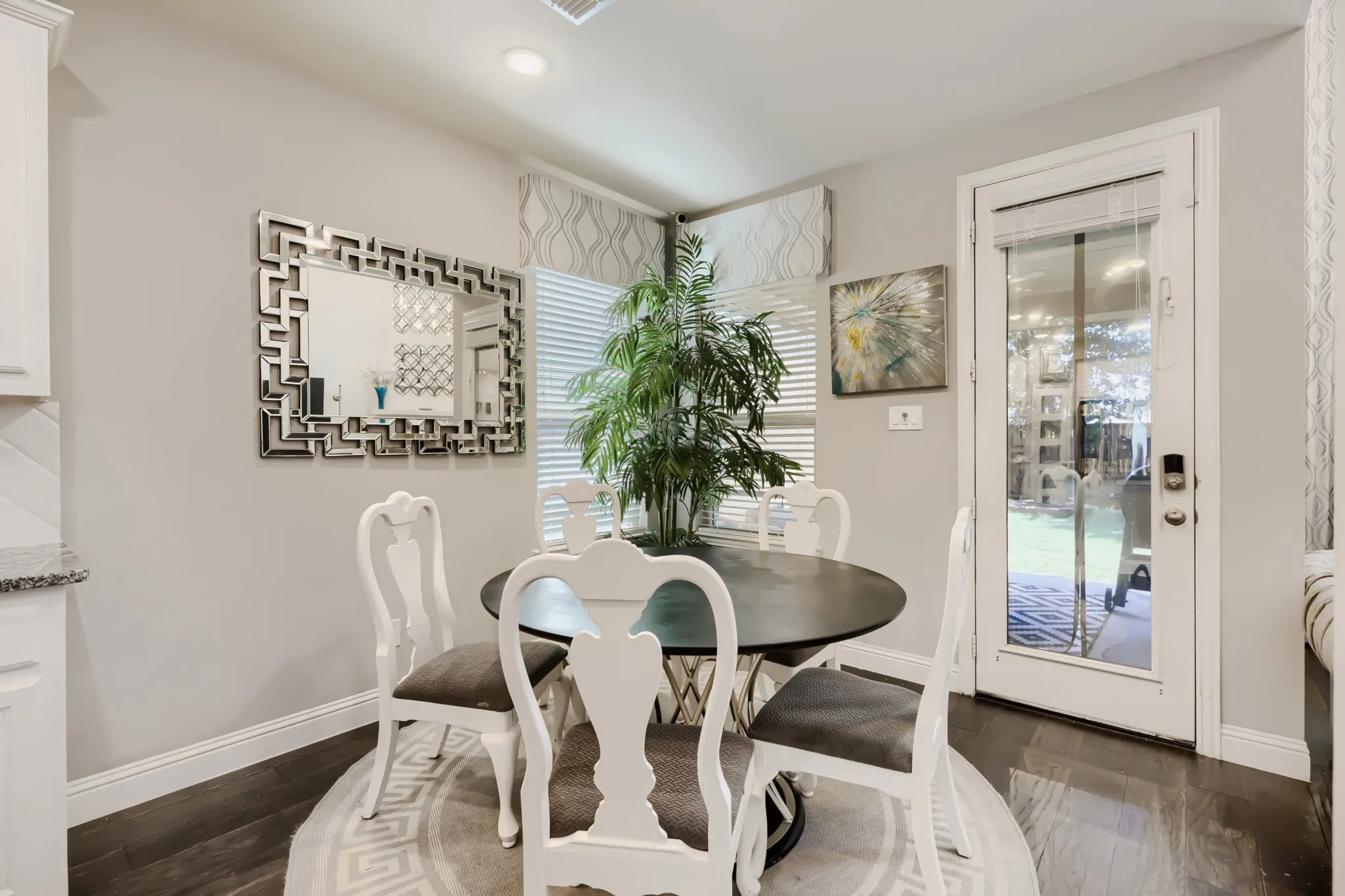 Dining area featuring wood-finish flooring and a glass-paneled exterior door