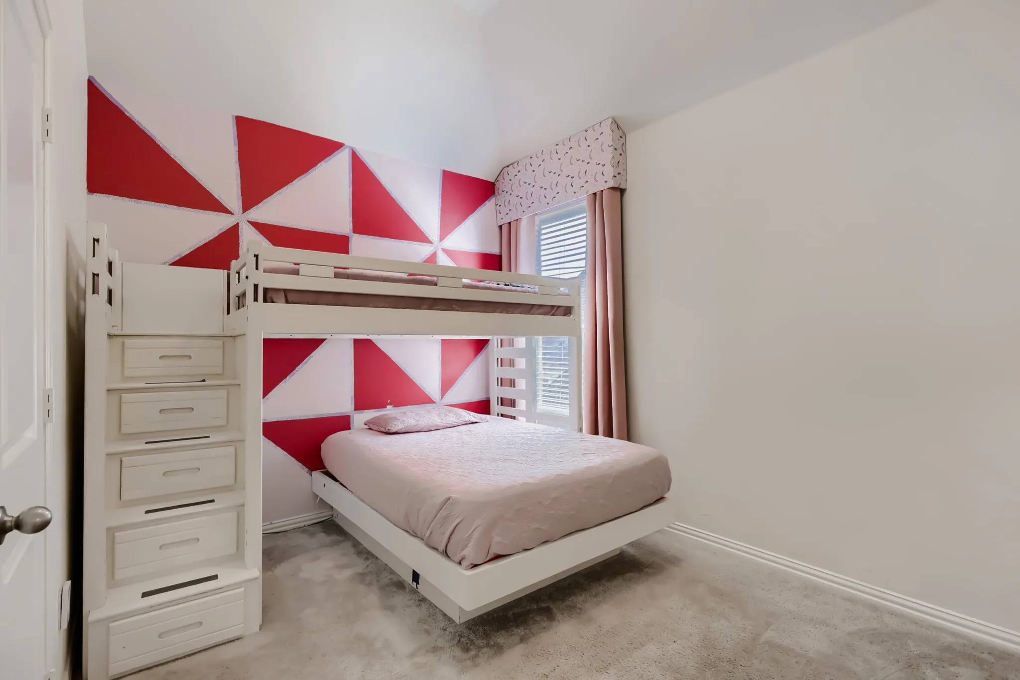 Geometric accent wall featuring red and white patterns