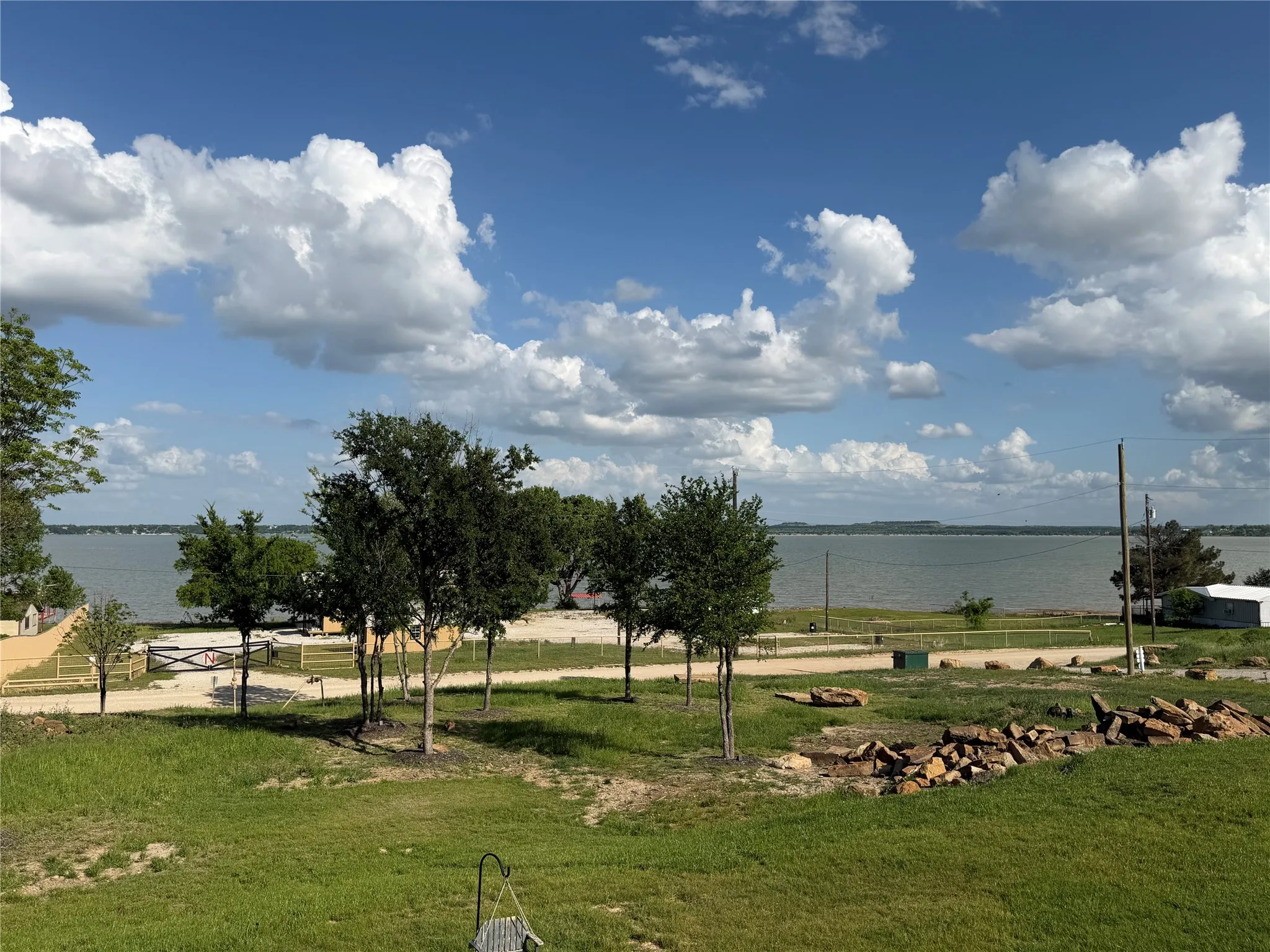 Take in the stunning lake view from the front yard, where the seller has started building a firepit with rocks already found on the property.