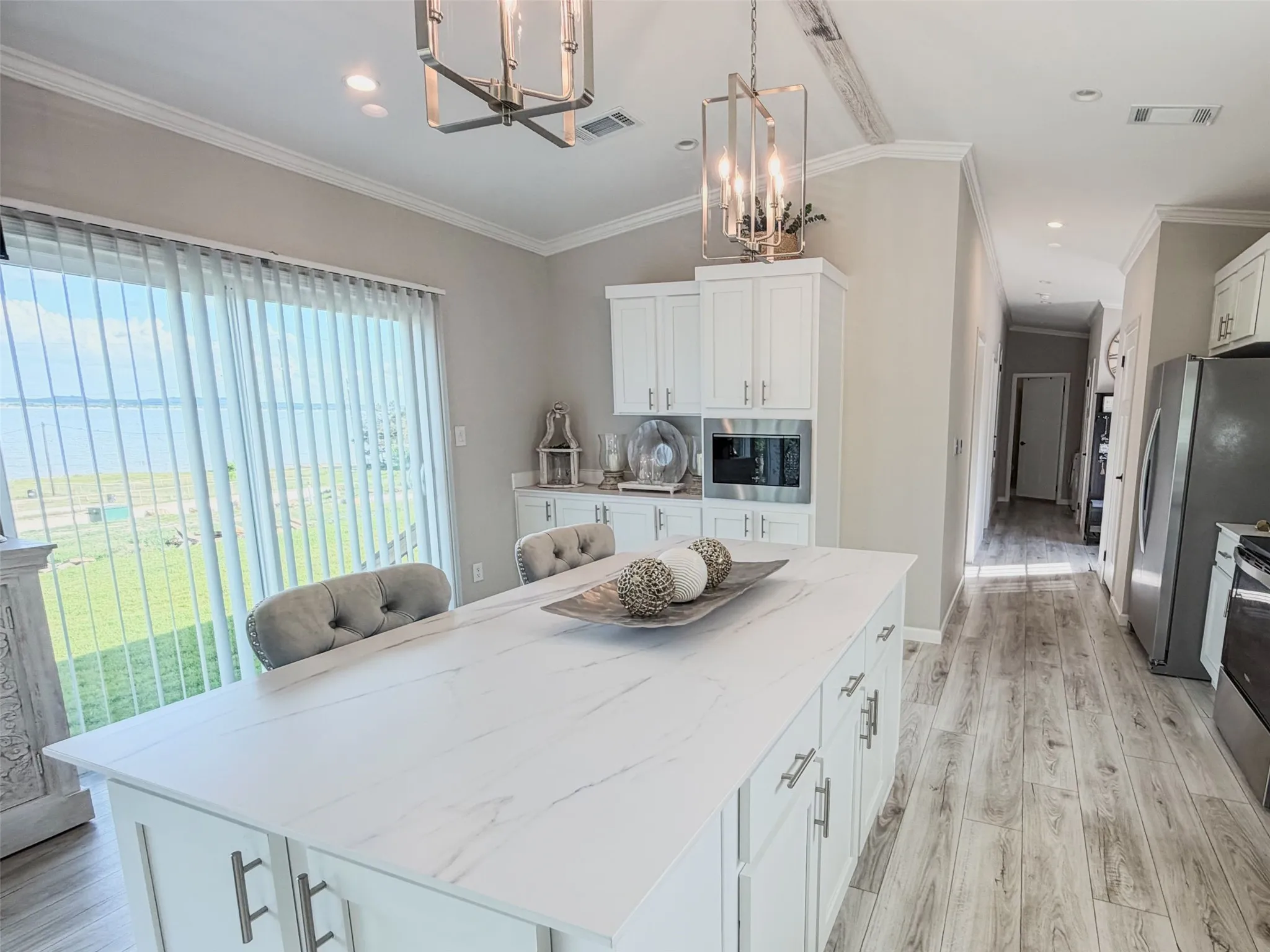 Spacious island featuring plenty of storage and a multiple built-in electric outlet.