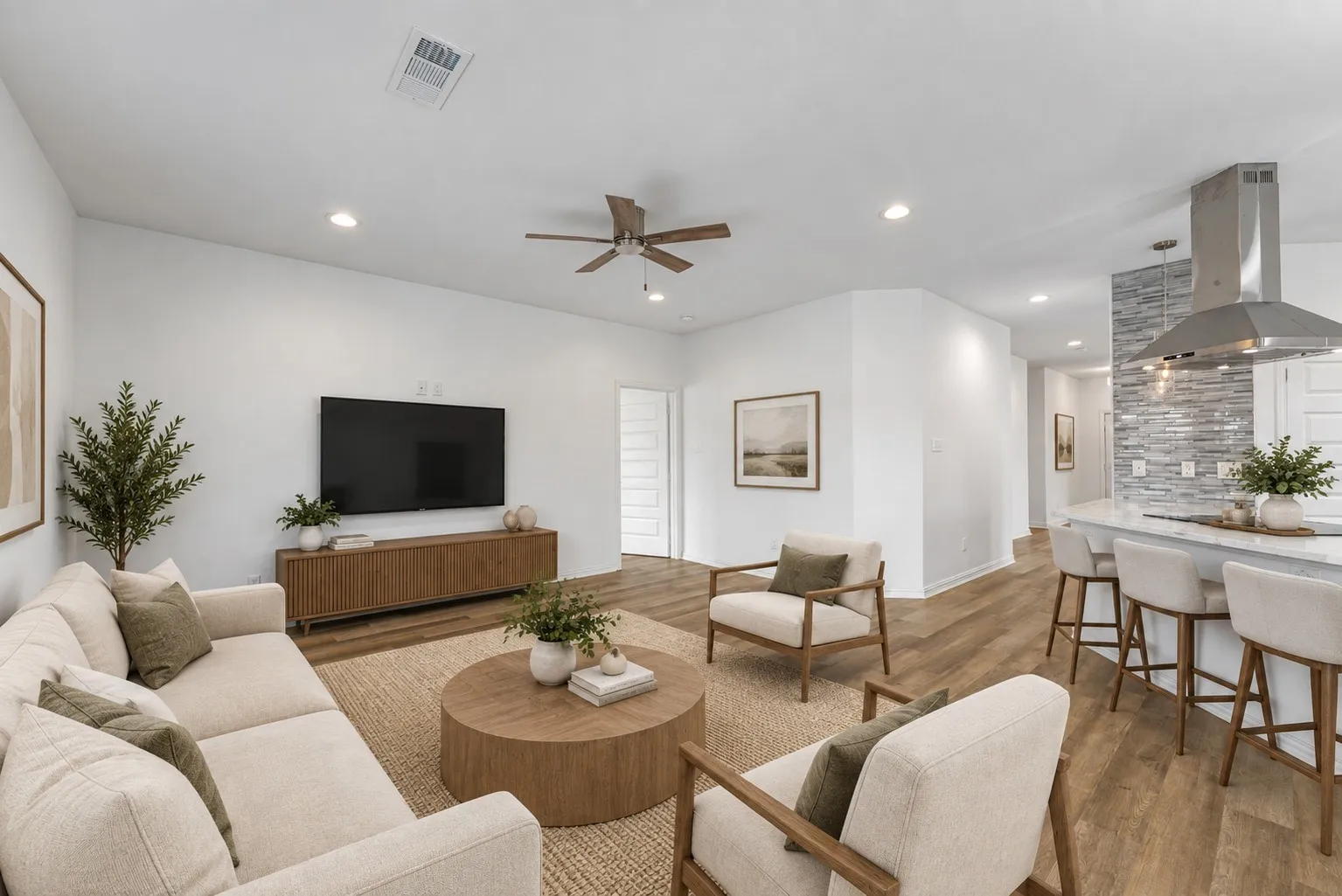 Open concept living area featuring wood-finish flooring, recessed lighting, and a ceiling fan