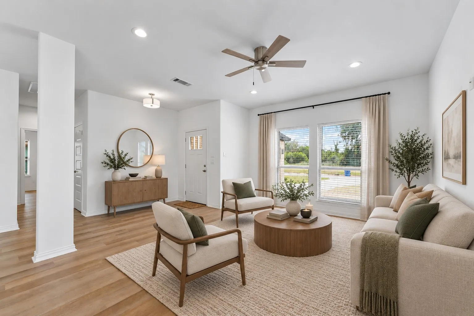 Spacious living area featuring wood-finish flooring, recessed lighting, and a ceiling fan