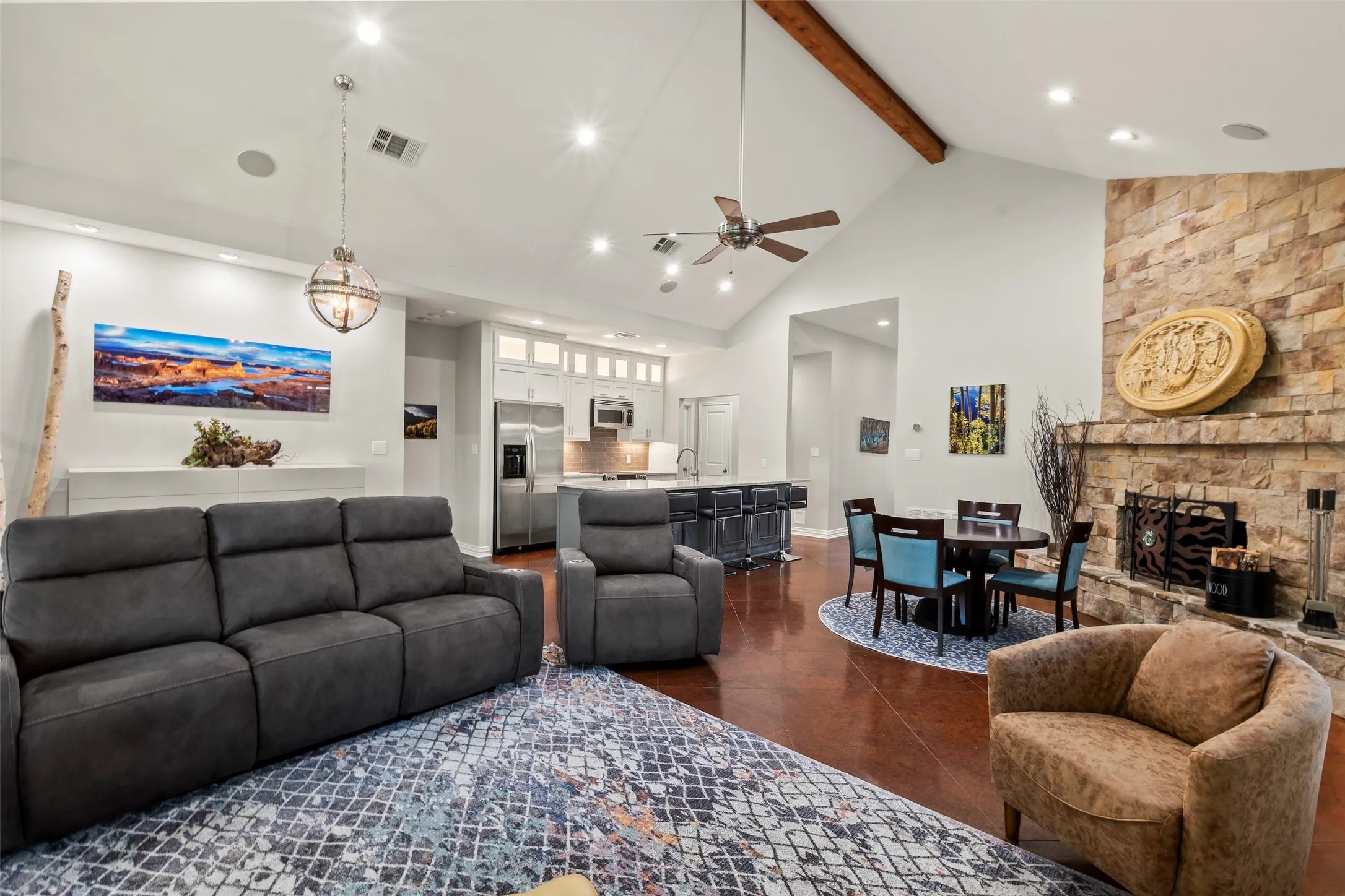 Open-concept floor plan with soaring vaulted ceilings and scored concrete floors.
