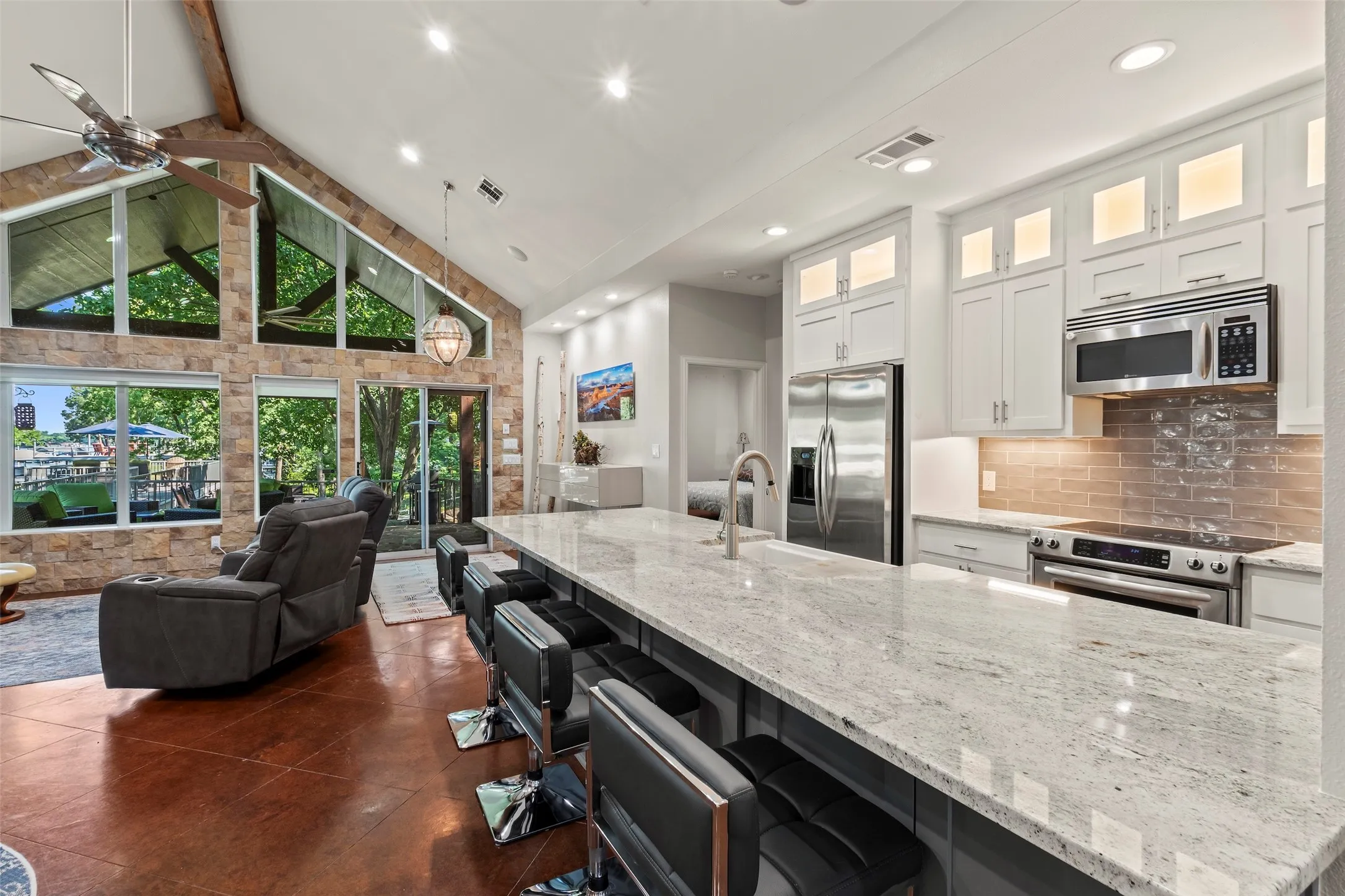 Bright and updated kitchen with white cabinetry and granite countertops.
