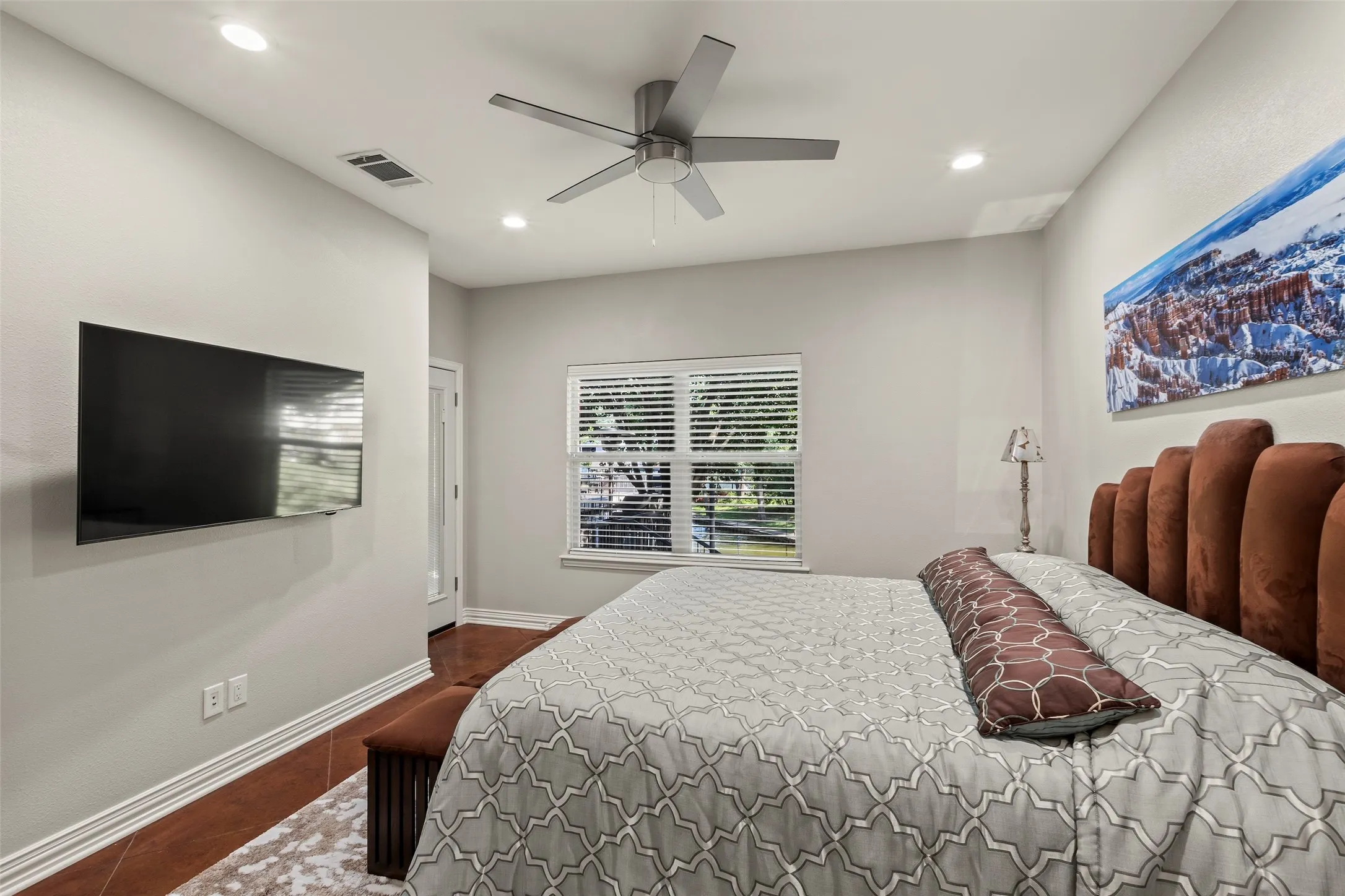 Lakeside owner’s suite opens directly to the covered porch for morning views.