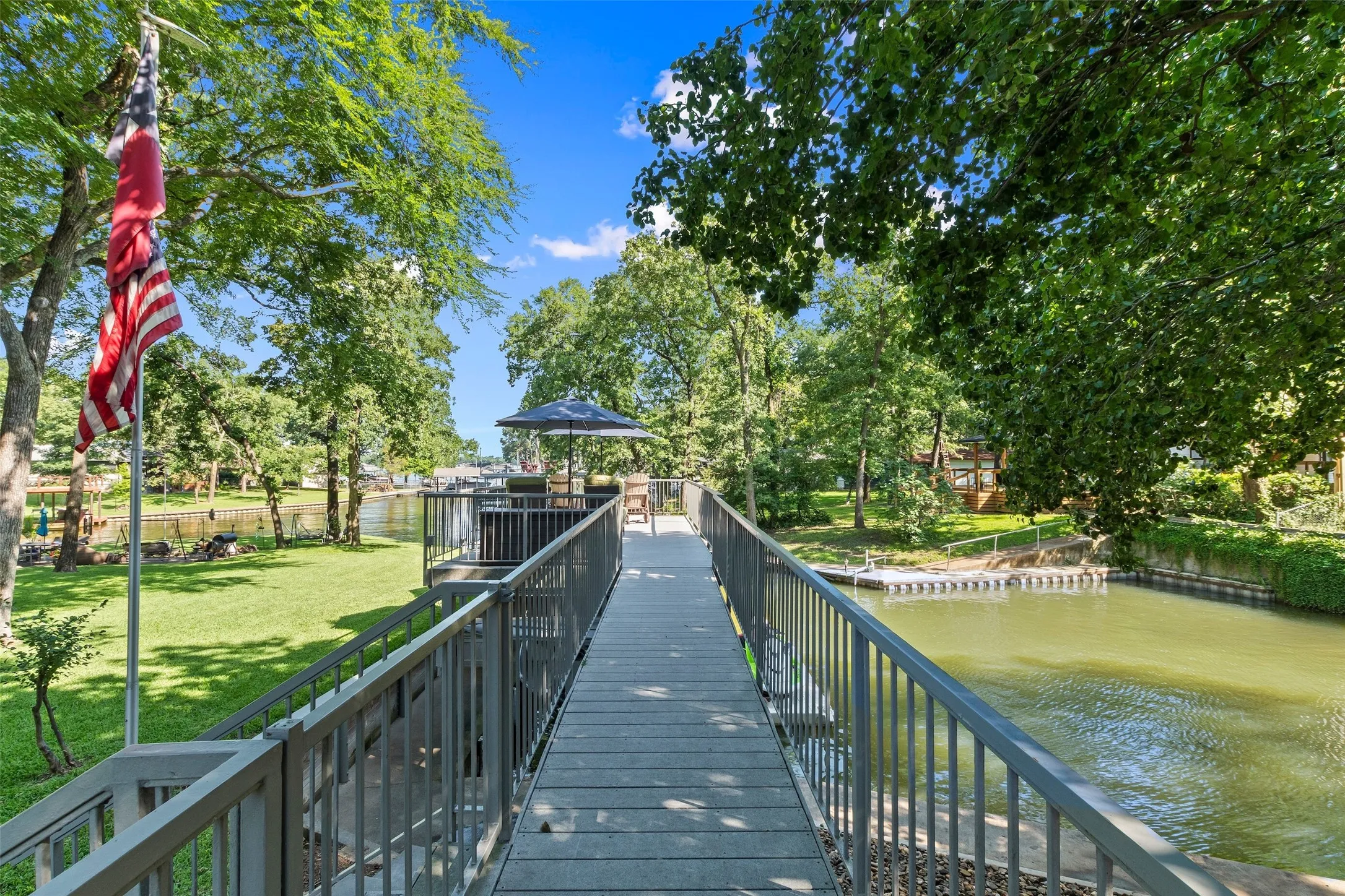 Pet-friendly side yard with chain link fencing and lake pump-fed sprinkler system.