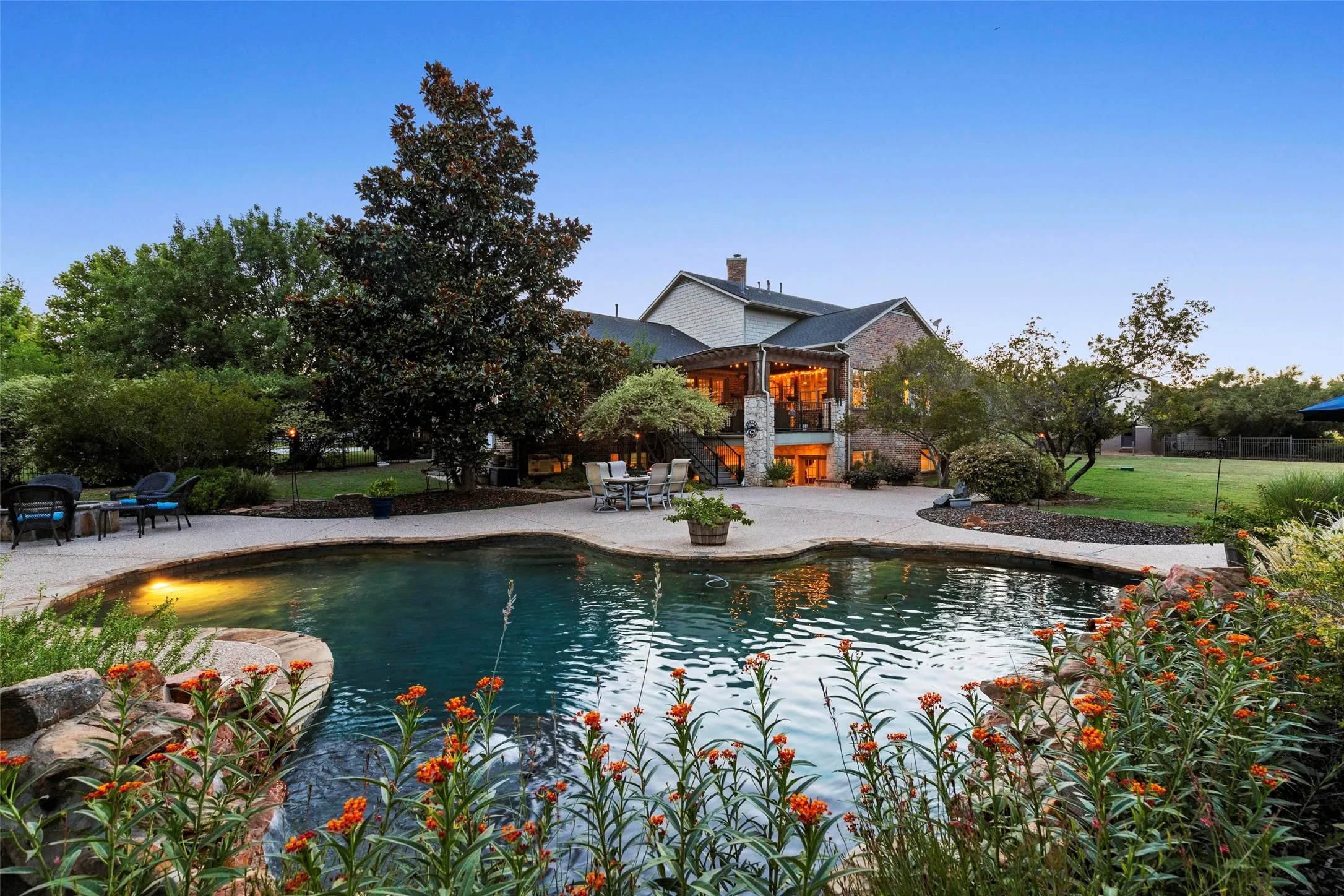 1.4 acres with gorgeous pool and professional landscaping.