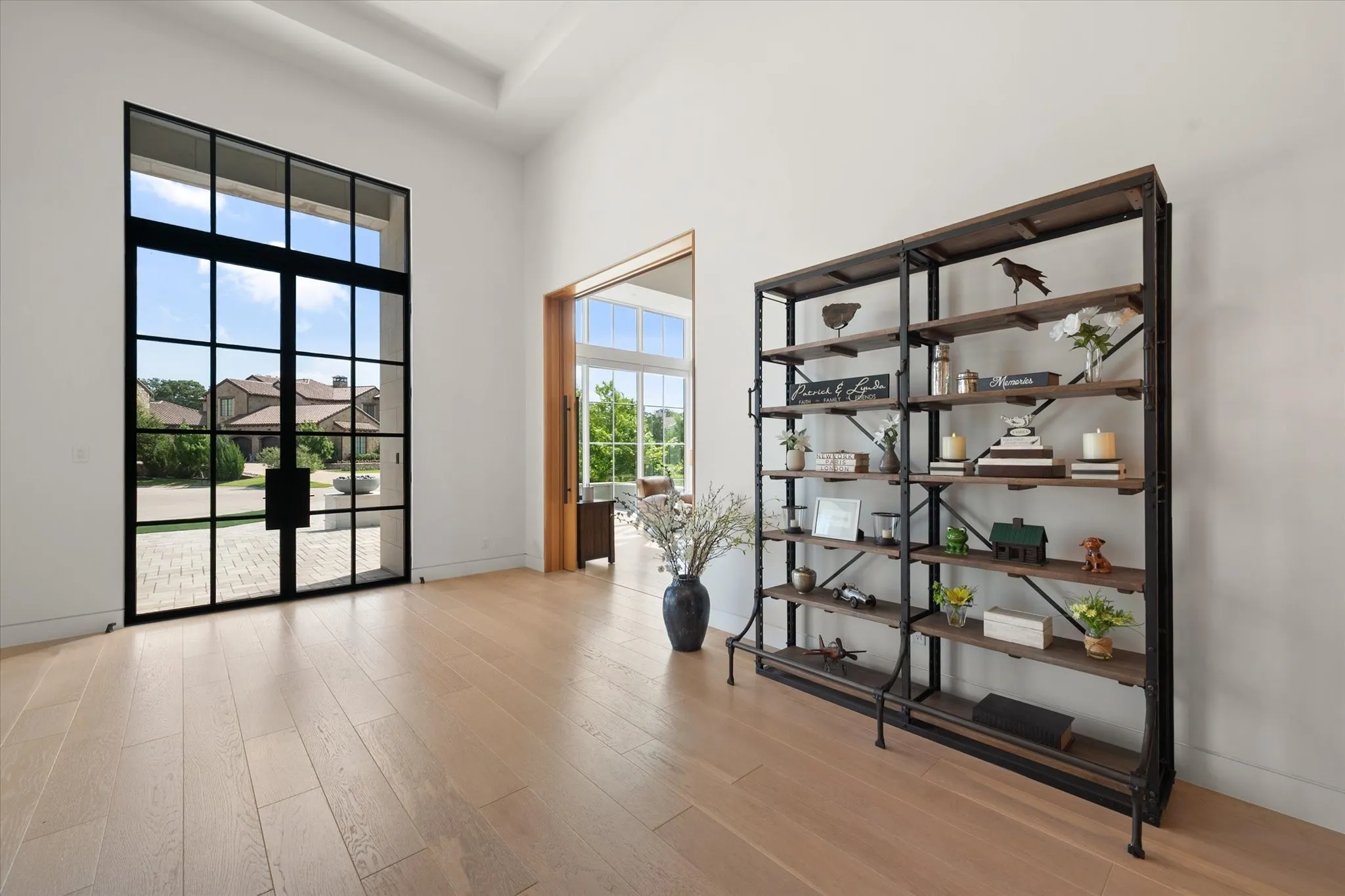 Front door entry of the home with large pane Marvin Hurricane rated windows throughout the residence