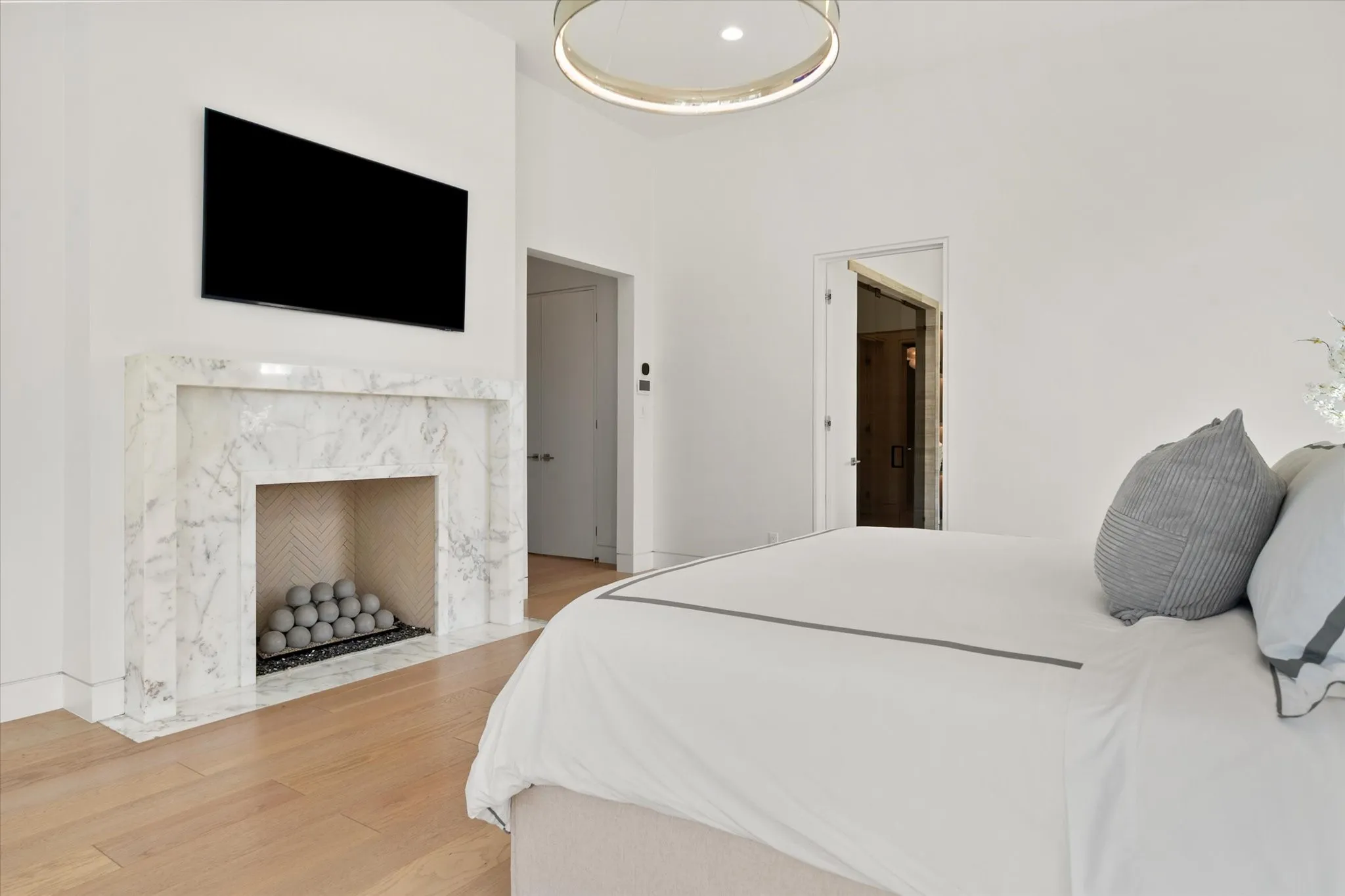 Contemporary fireplace with a herringbone tile interior and a mounted television above.