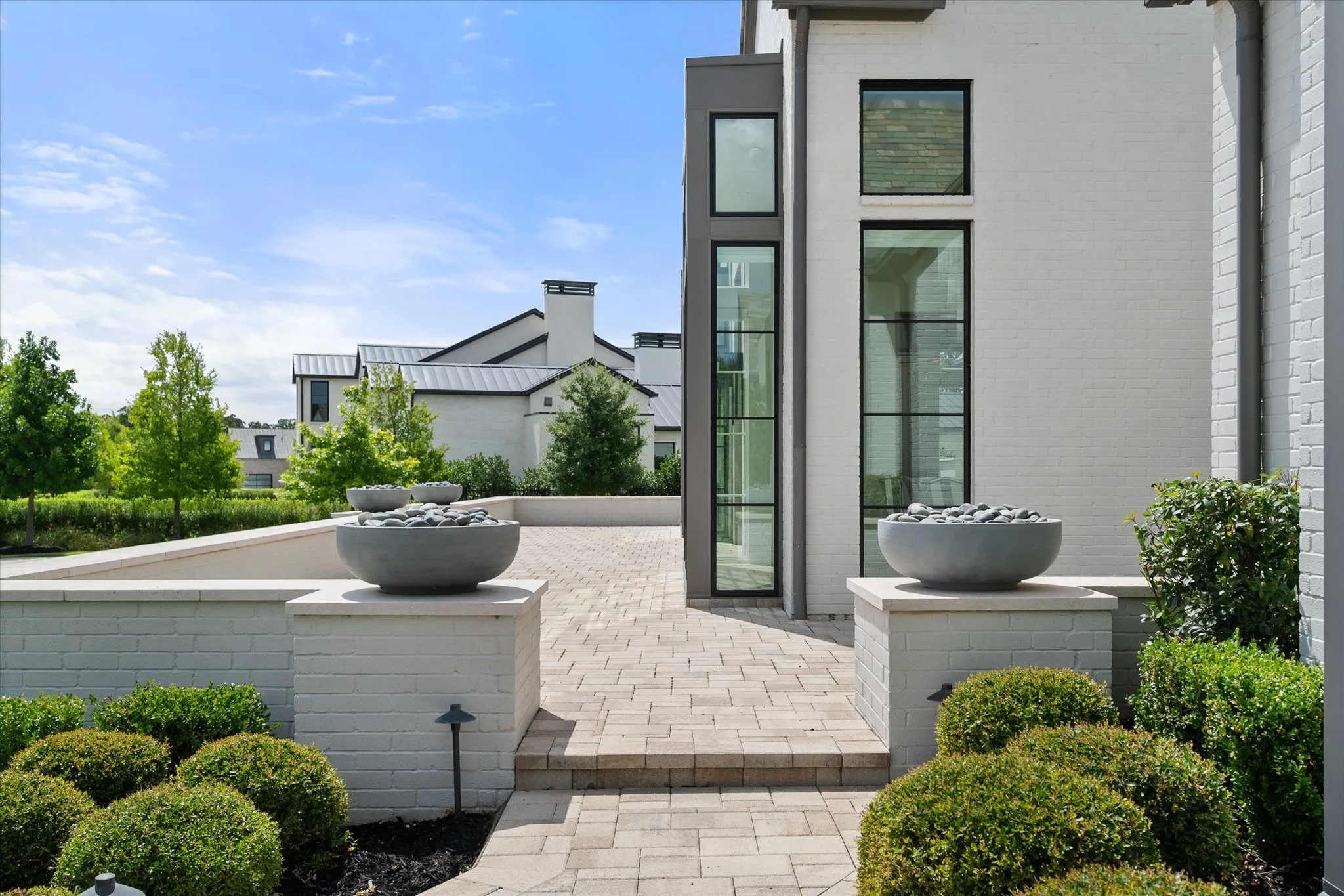 Brick exterior with dark-framed windows and trim.