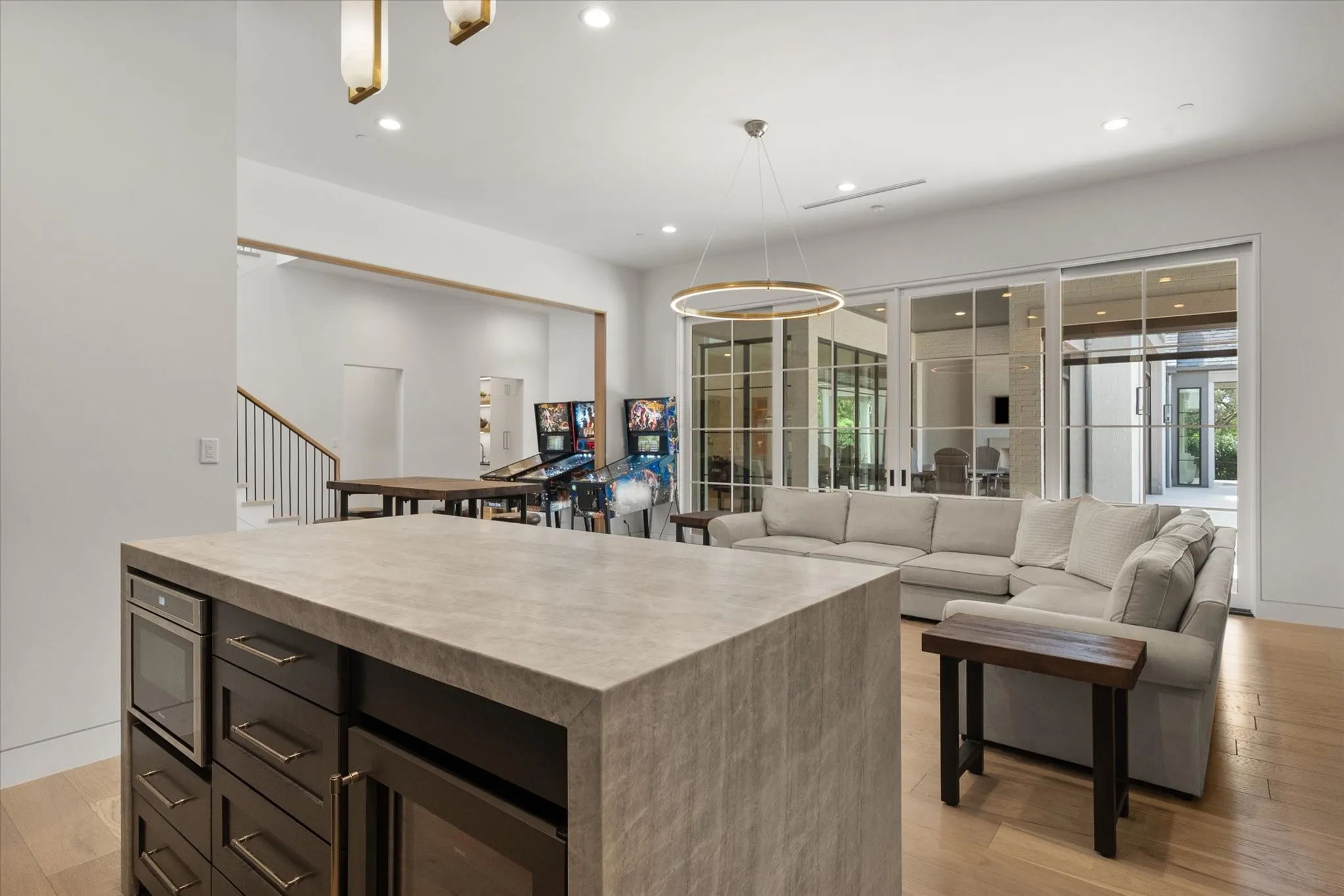 First floor game room and island with a microwave bar area just outside the media room.