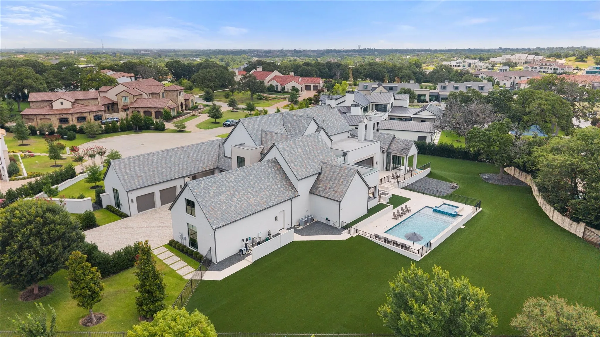 Contemporary white exterior with multiple gables and a gray slate roof