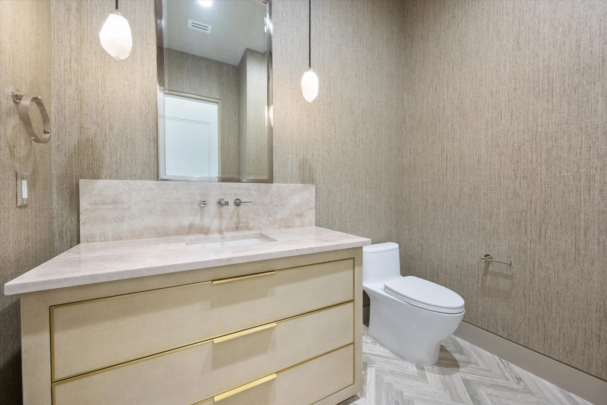 Guest bathroom with vanity and light-toned countertop.