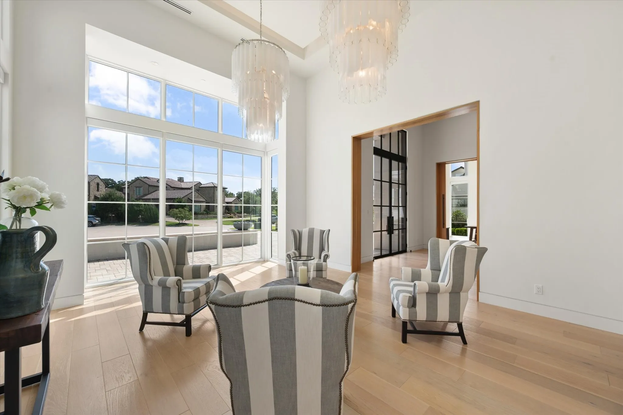 Front formal dining or sitting area. Rift white oak flooring throughout primary living areas and Level 4 drywall finish throughout the home.