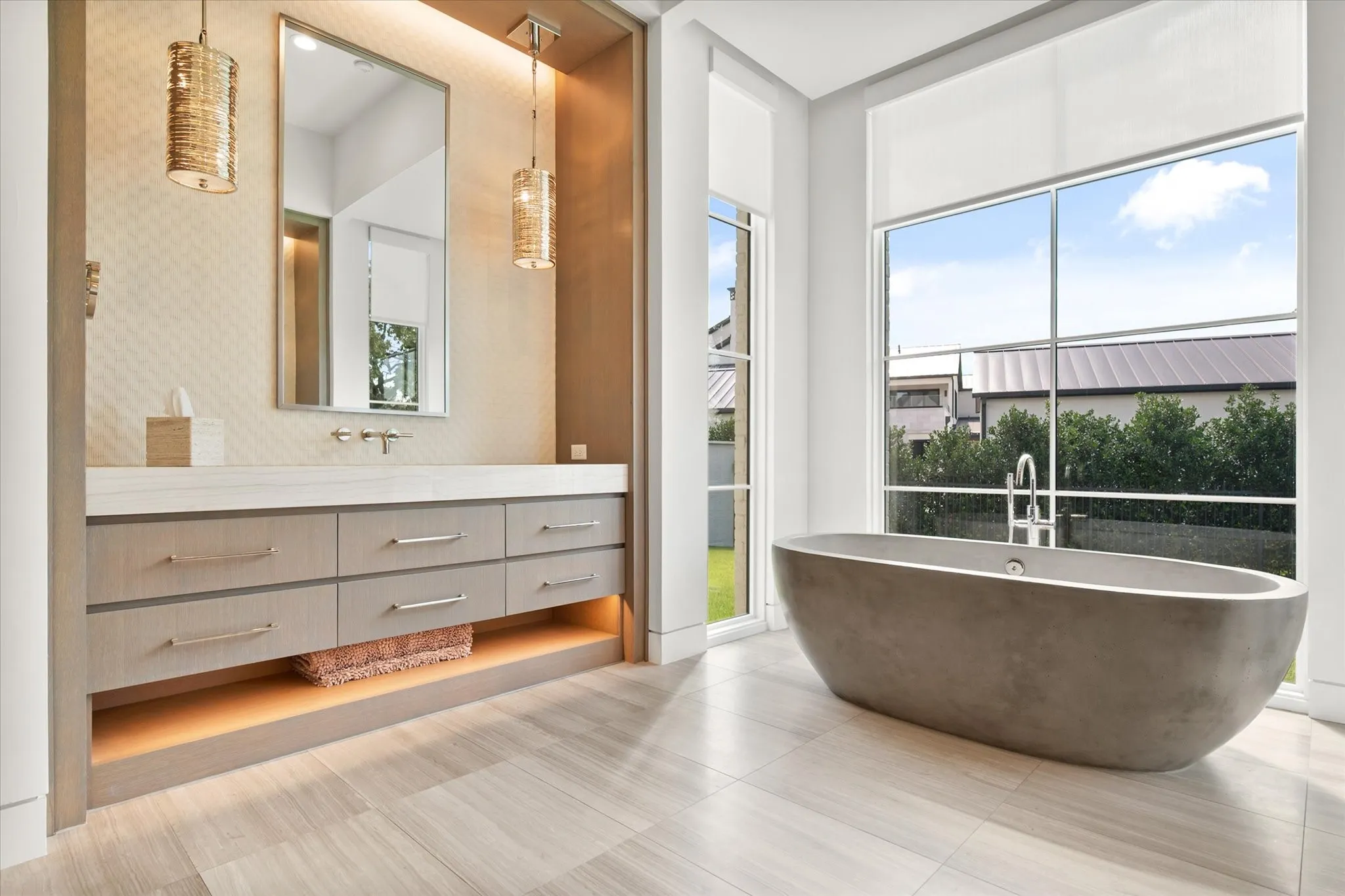 Contemporary primary bathroom featuring a freestanding tub, large windows, and a double vanity with ample storage. Essential oil steam shower feature in primary bathroom.