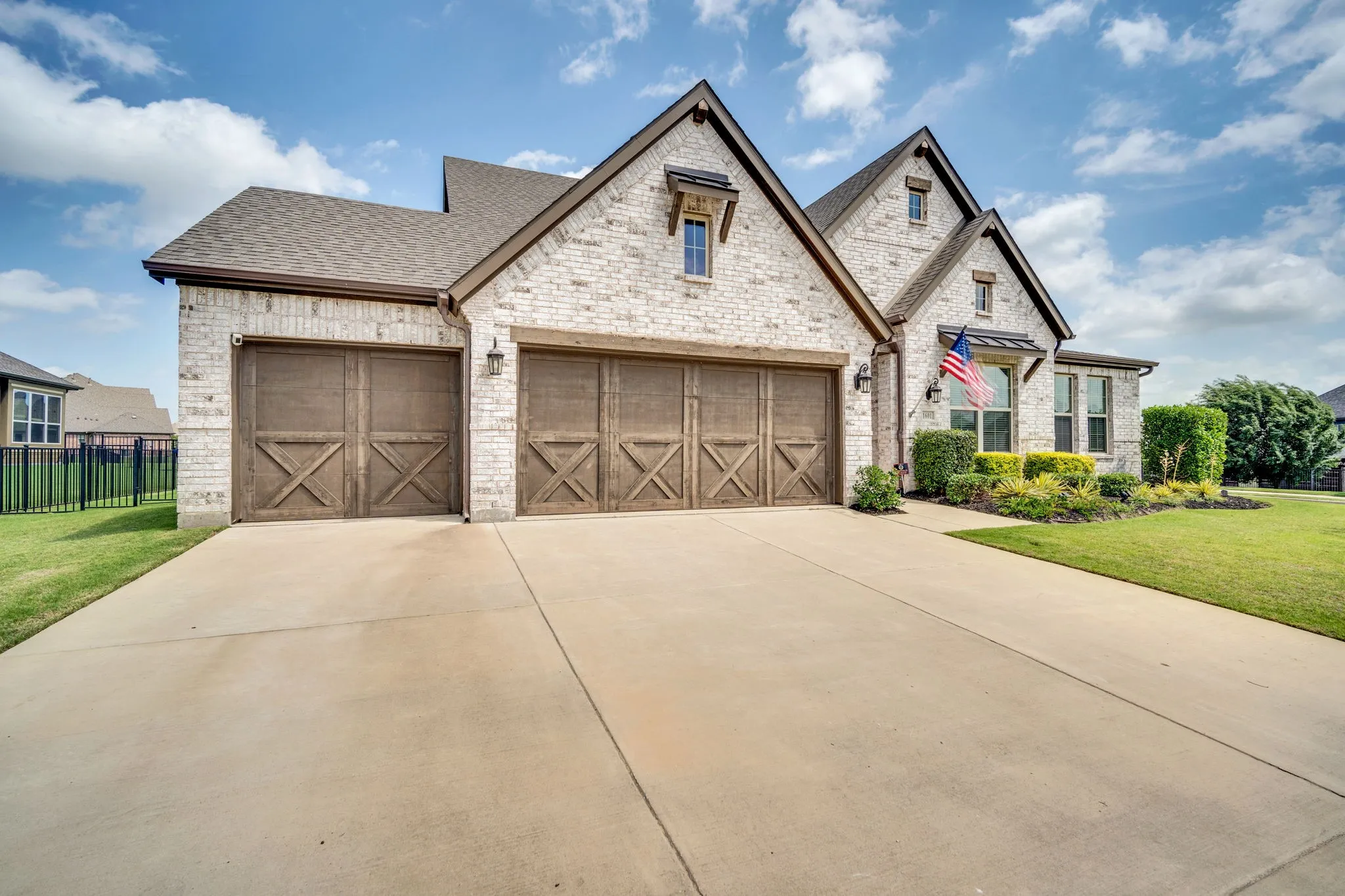 Cream brick exterior featuring multiple gables and a dark shingle roof