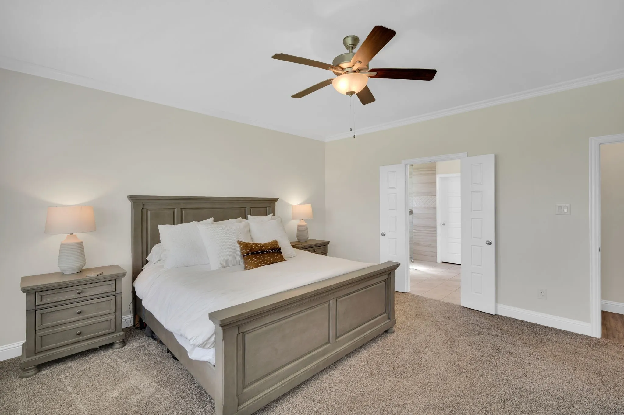 Bedroom featuring plush carpeting and a ceiling fan with integrated lighting