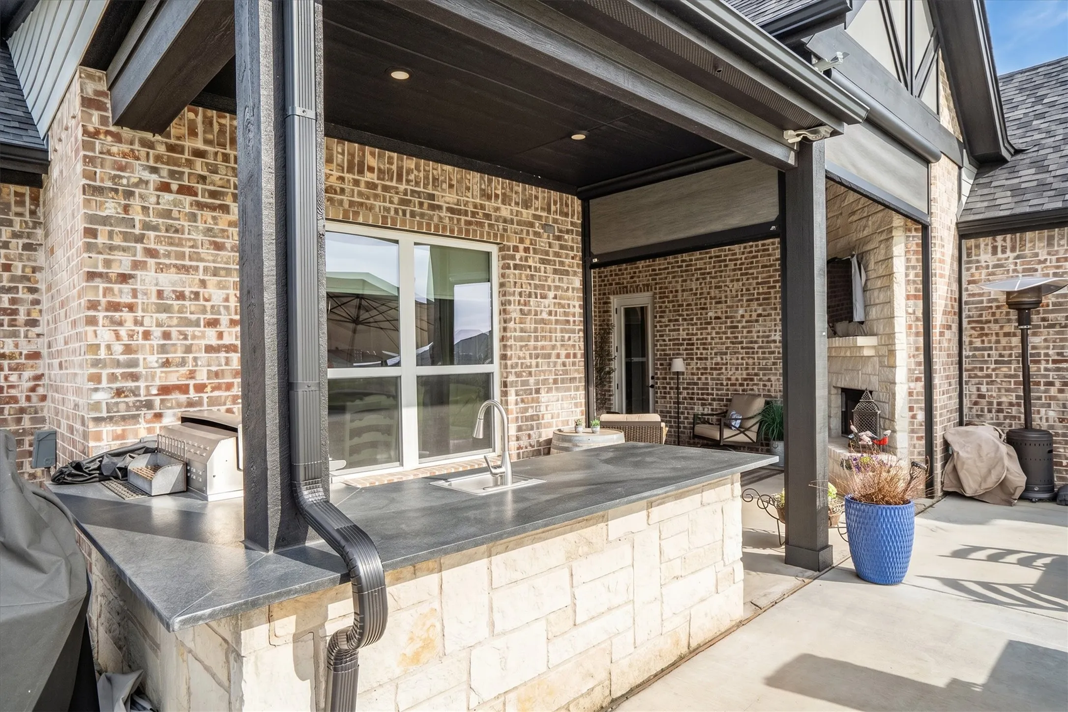 Another view of the outdoor kitchen and living spaces.