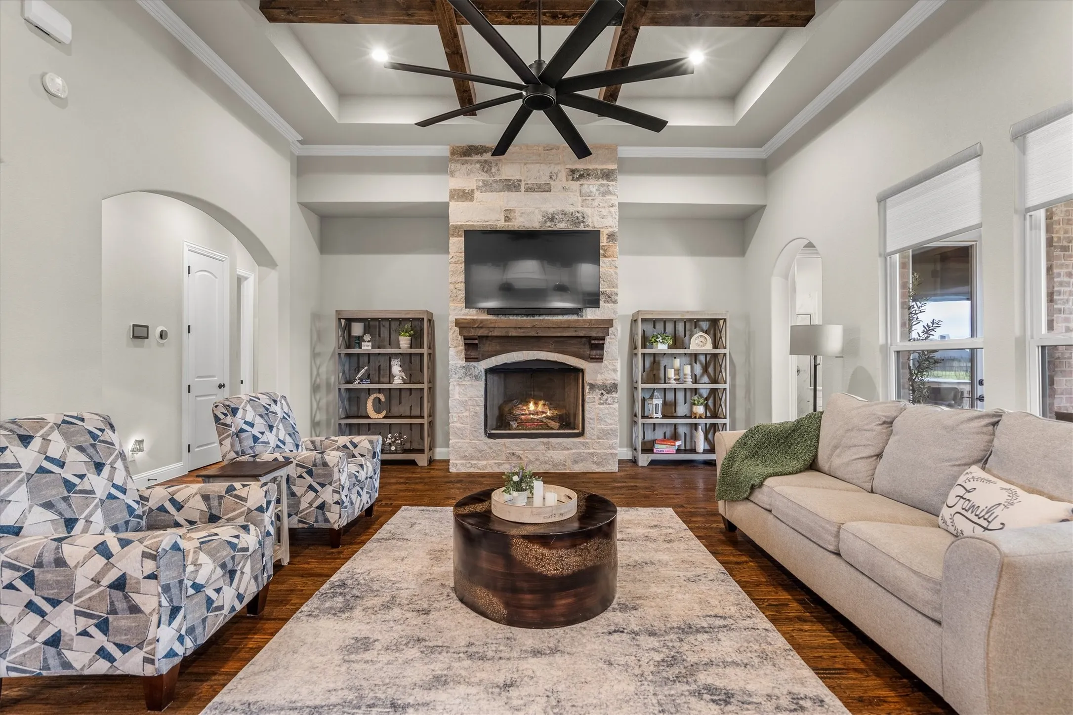 The high ceilings, stone fireplace, and exposed beams in the living room are a great mix of luxury and comfortable!