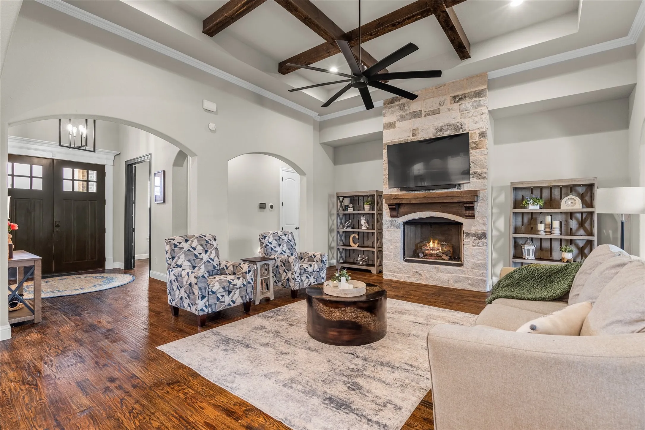 The main living room is anchored by a stone fireplaced, wall of windows overlooking the back of the property and is open to the kitchen and dining area.