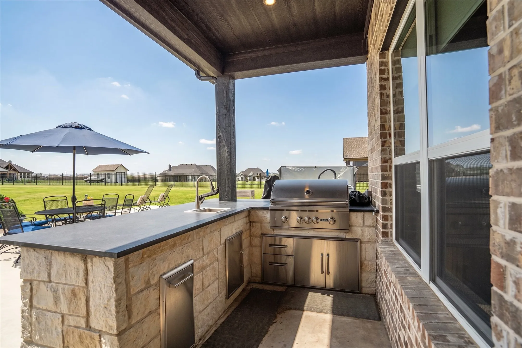 The 8X11 outdoor kitchen is covered with a large granite breakfast bar for outdoor events.
