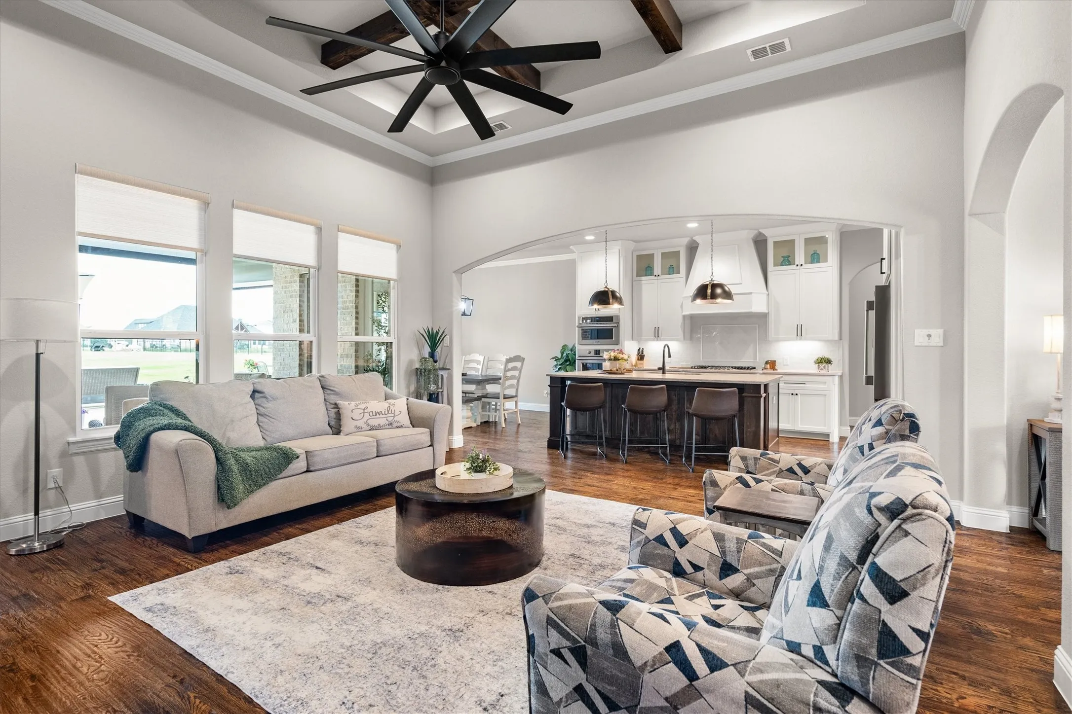 The living room opens to the gourmet kitchen and overlooks the back of the property.