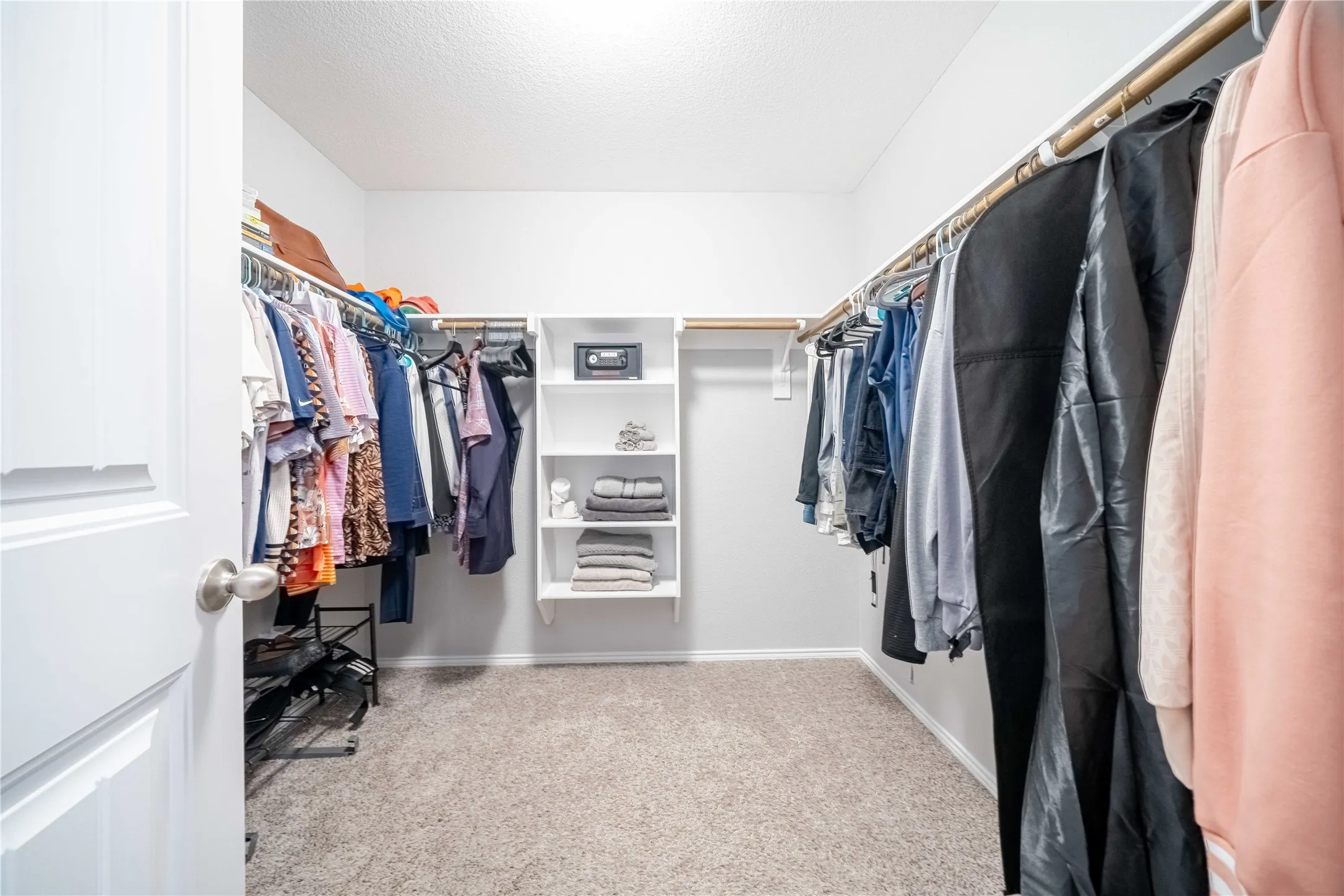 Spacious closet with light colored carpet