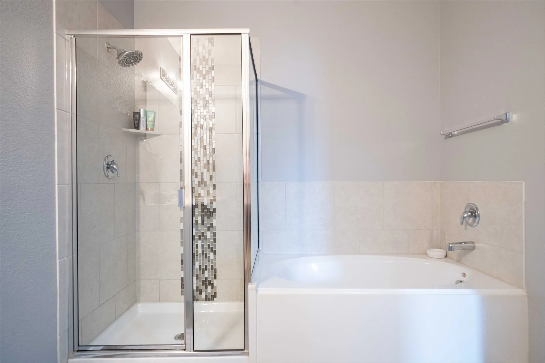 Bathroom featuring shower with separate bathtub